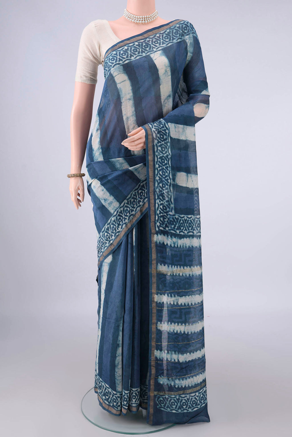 Blue Grey Chanderi Cotton Saree with Batik Print on the body and Thin Zari Line.  displayed on a mannequin