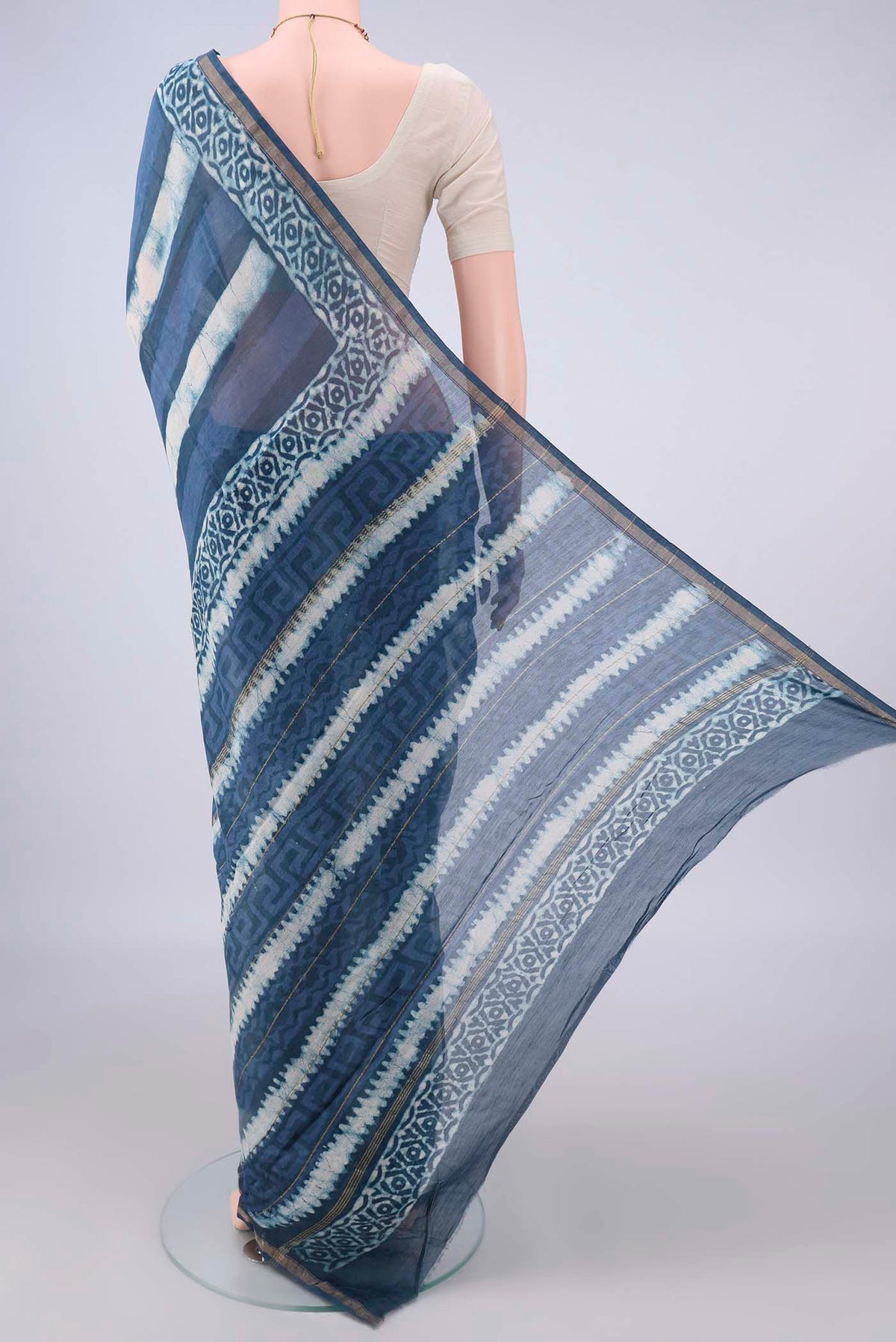 Flat view of Blue Grey Chanderi Cotton Saree with Batik Print on the body and Thin Zari Line. 