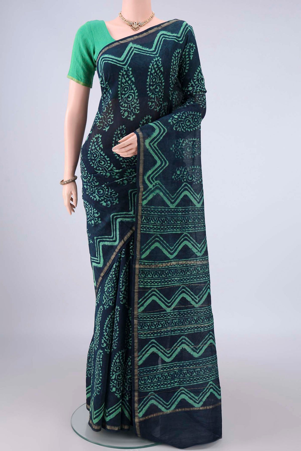 Indigo Chanderi Cotton Saree with Batik Print on the body and Thin Zari Line.  displayed on a mannequin