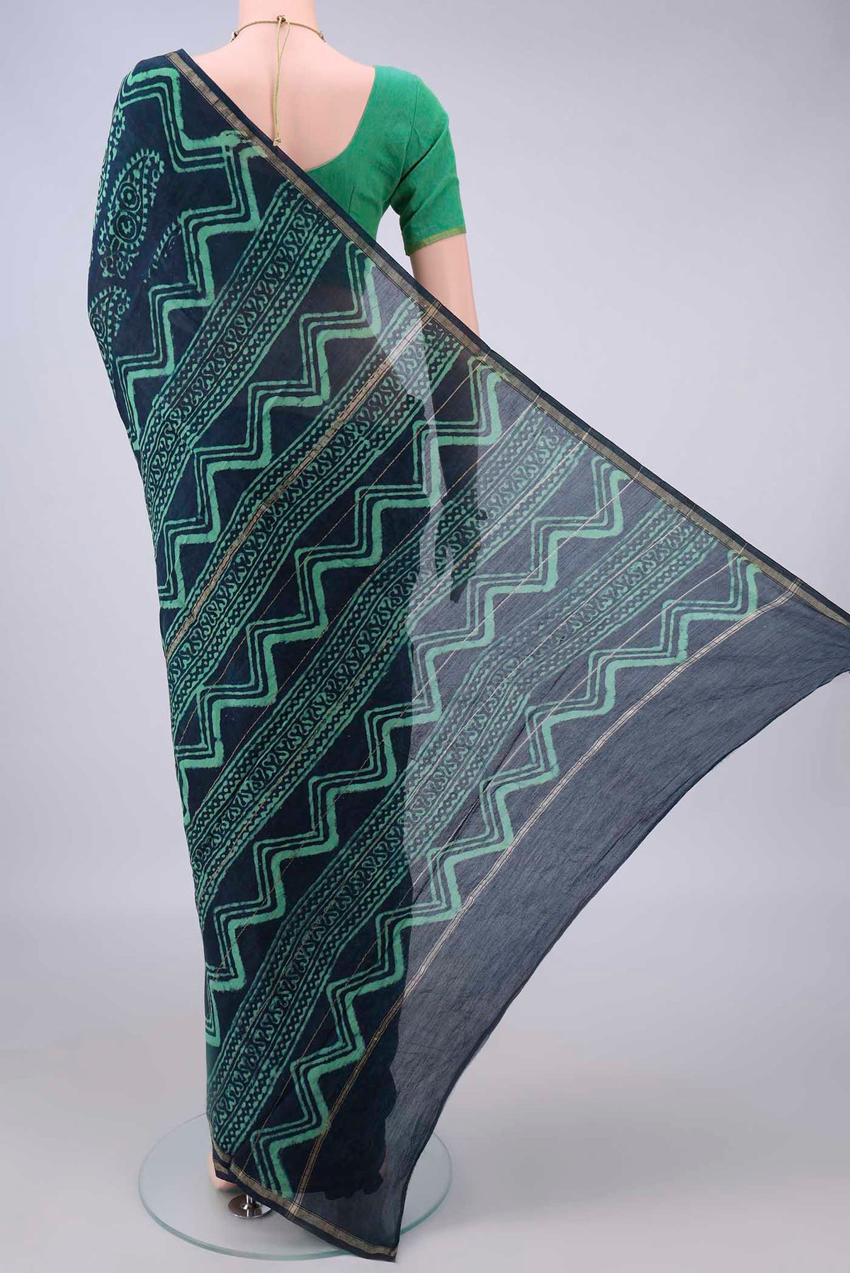 Flat view of Indigo Chanderi Cotton Saree with Batik Print on the body and Thin Zari Line. 