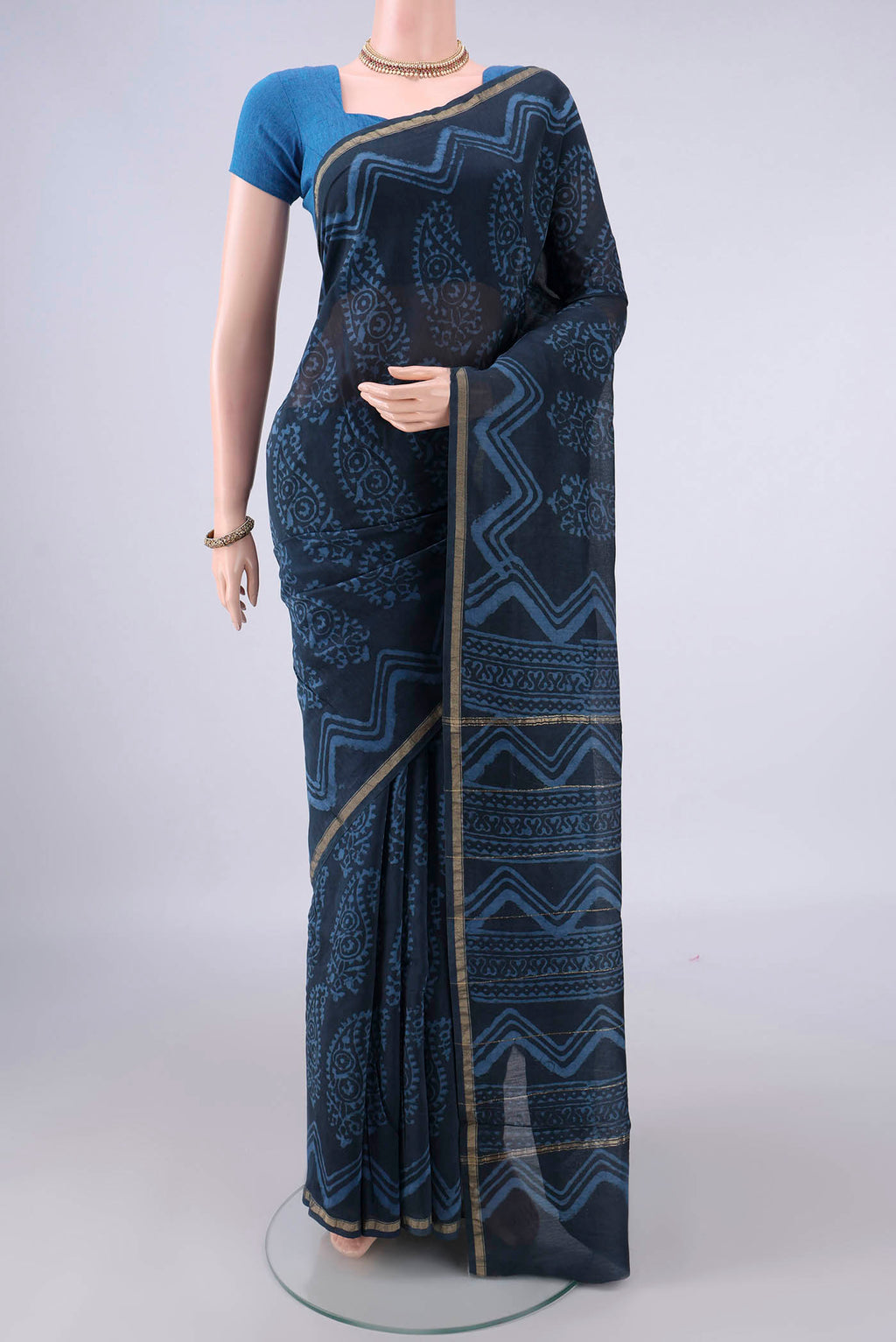Indigo Chanderi Cotton Saree with Batik Print on the body and Thin Zari Line.  displayed on a mannequin