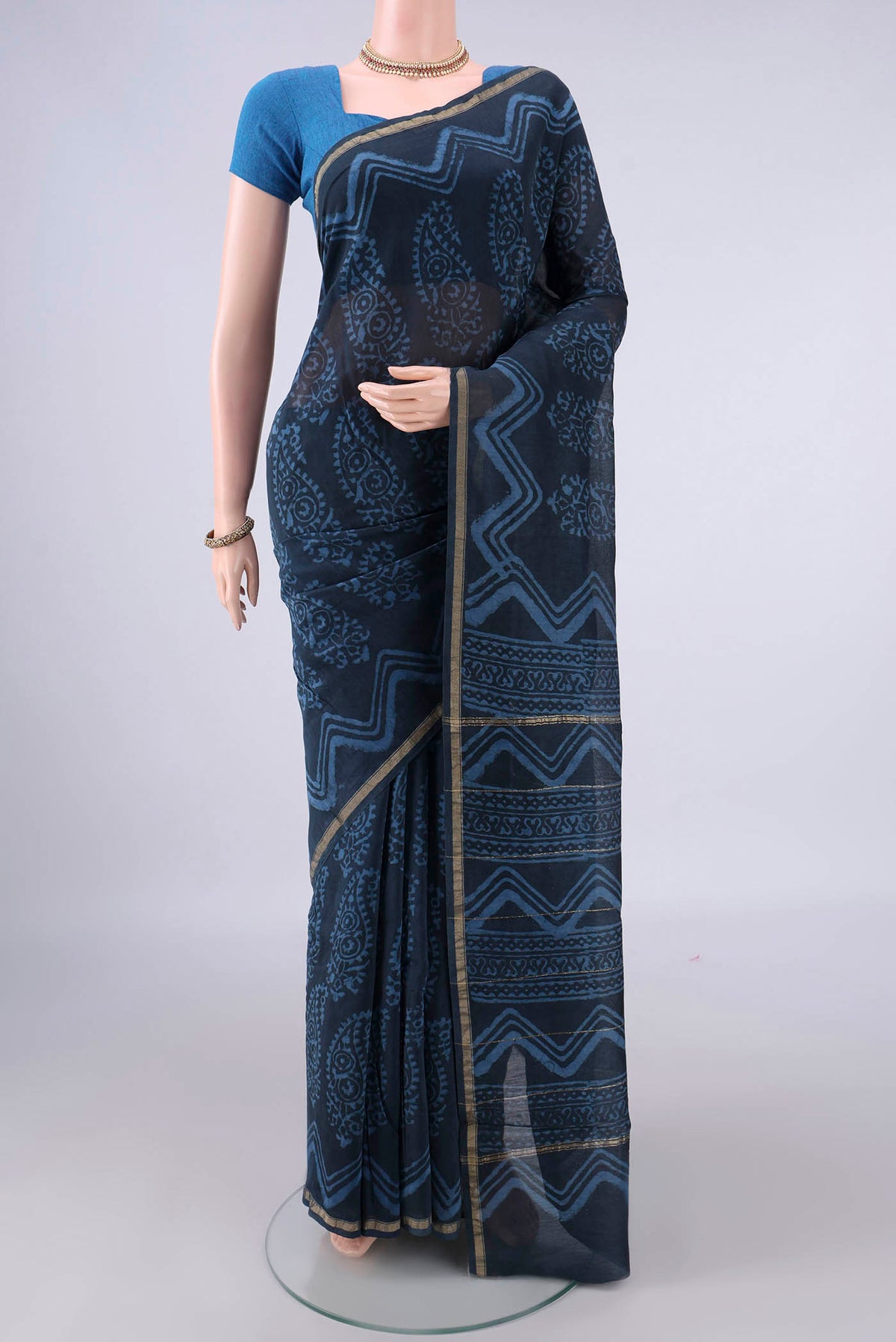 Indigo Chanderi Cotton Saree with Batik Print on the body and Thin Zari Line.  displayed on a mannequin