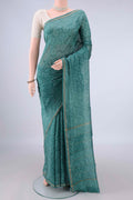 Green Chanderi Cotton Saree with Batik Print on the body and Thin Zari Line.  displayed on a mannequin