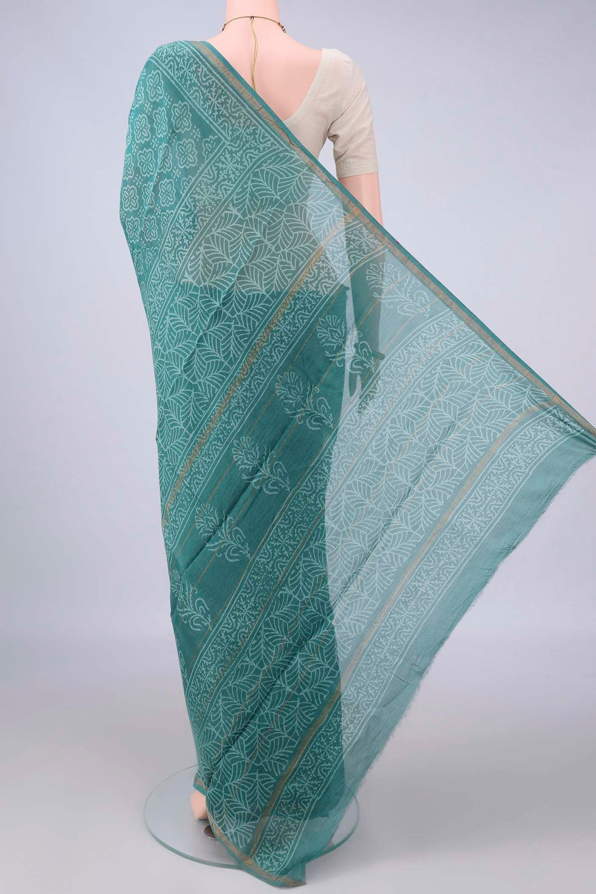 Flat view of Green Chanderi Cotton Saree with Batik Print on the body and Thin Zari Line. 