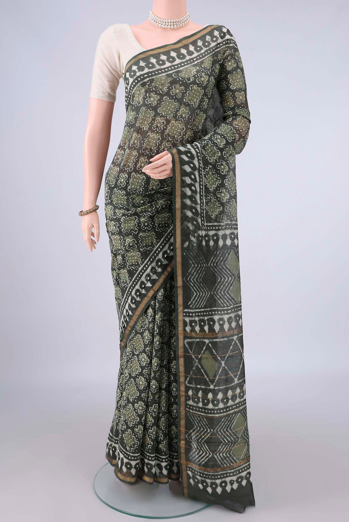 Mehandi Green Chanderi Cotton Saree with Batik Print on the body and Thin Zari Line.  displayed on a mannequin