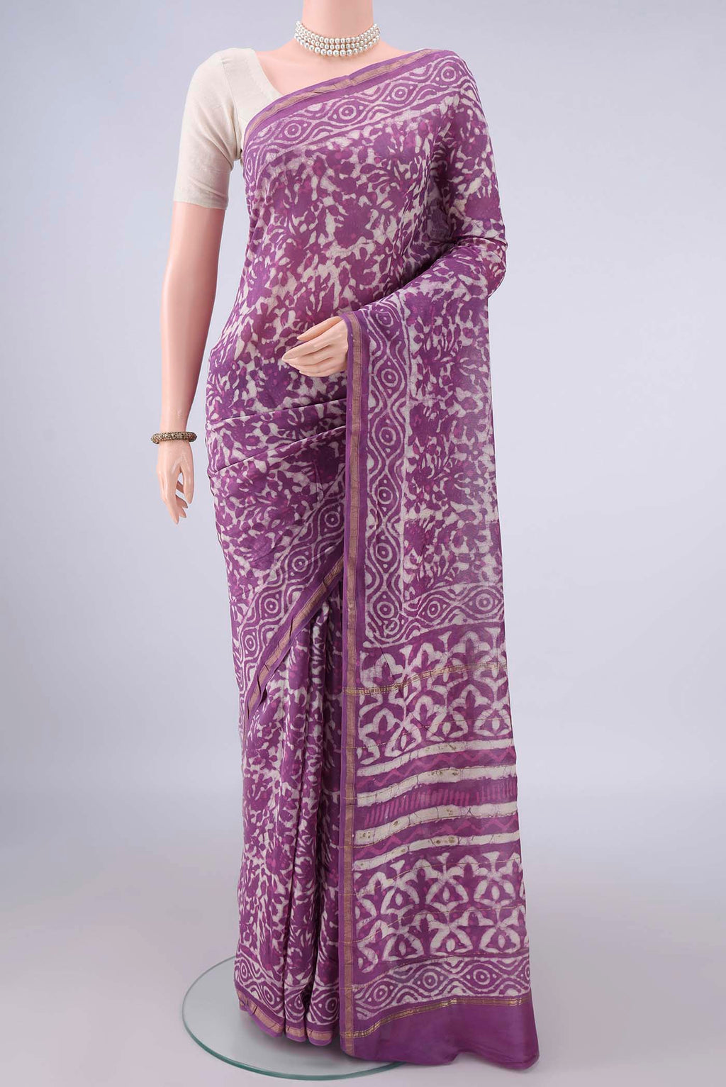 Purple Chanderi Cotton Saree with Batik Print on the body and Thin Zari Line.  displayed on a mannequin