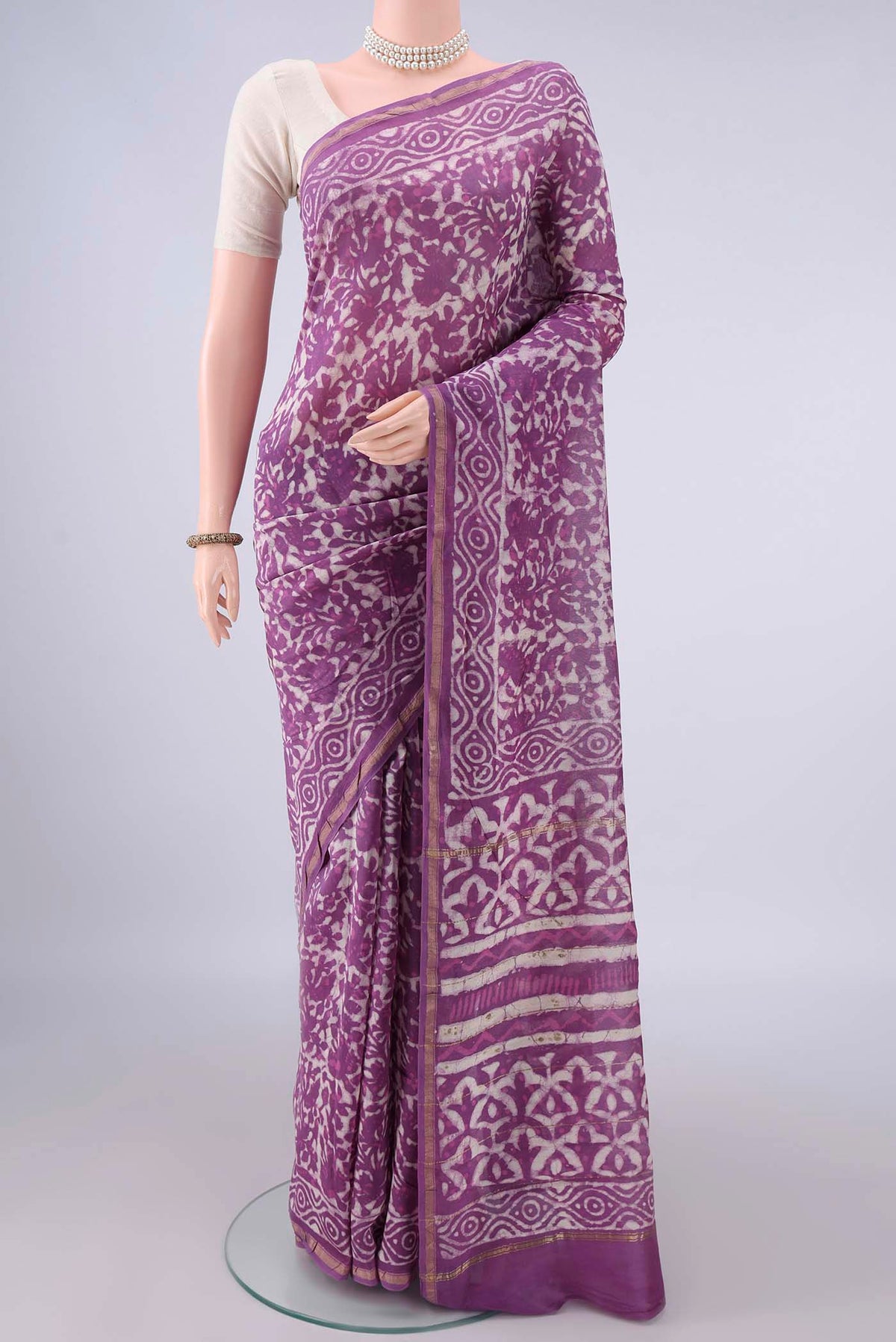 Purple Chanderi Cotton Saree with Batik Print on the body and Thin Zari Line.  displayed on a mannequin
