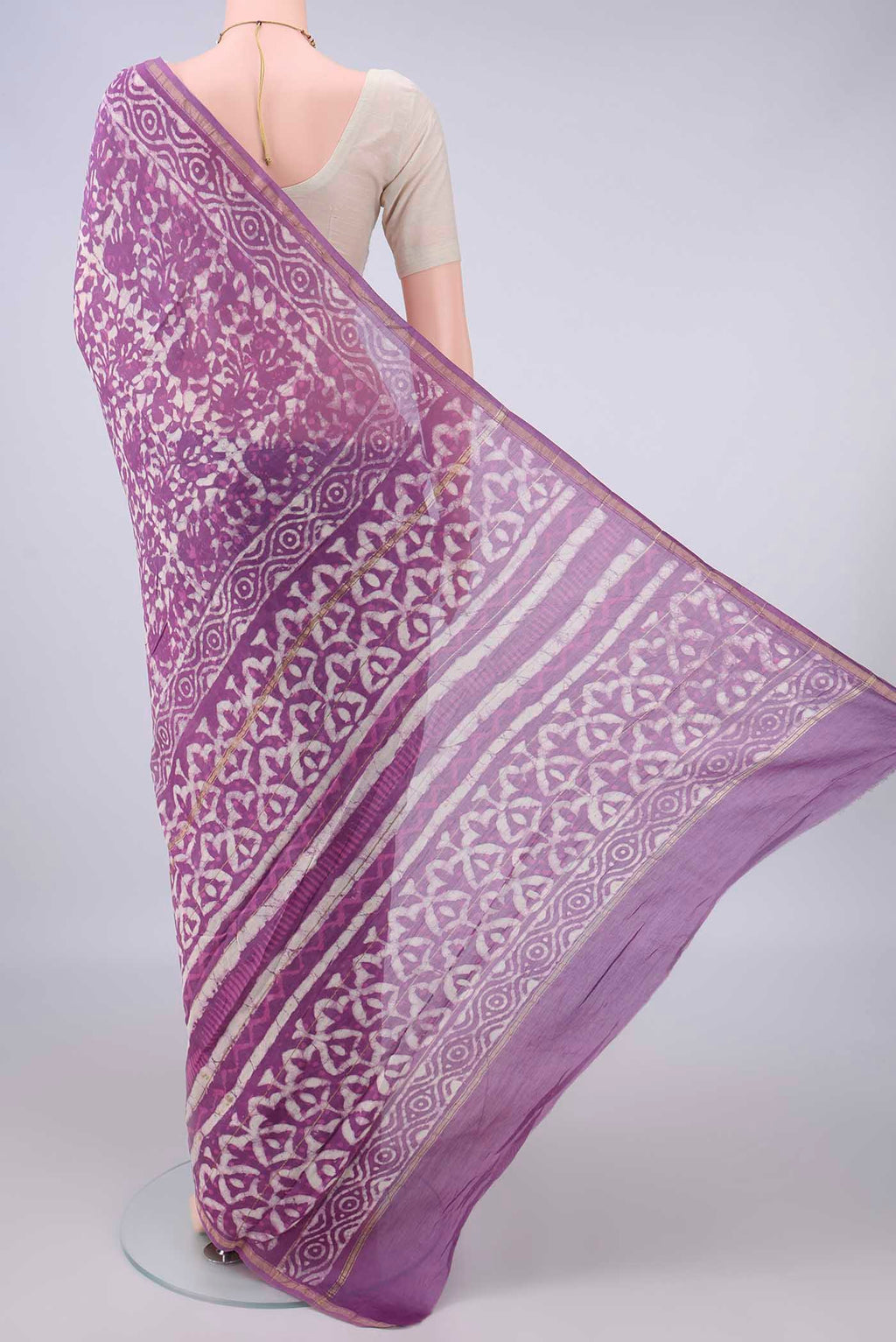 Flat view of Purple Chanderi Cotton Saree with Batik Print on the body and Thin Zari Line. 