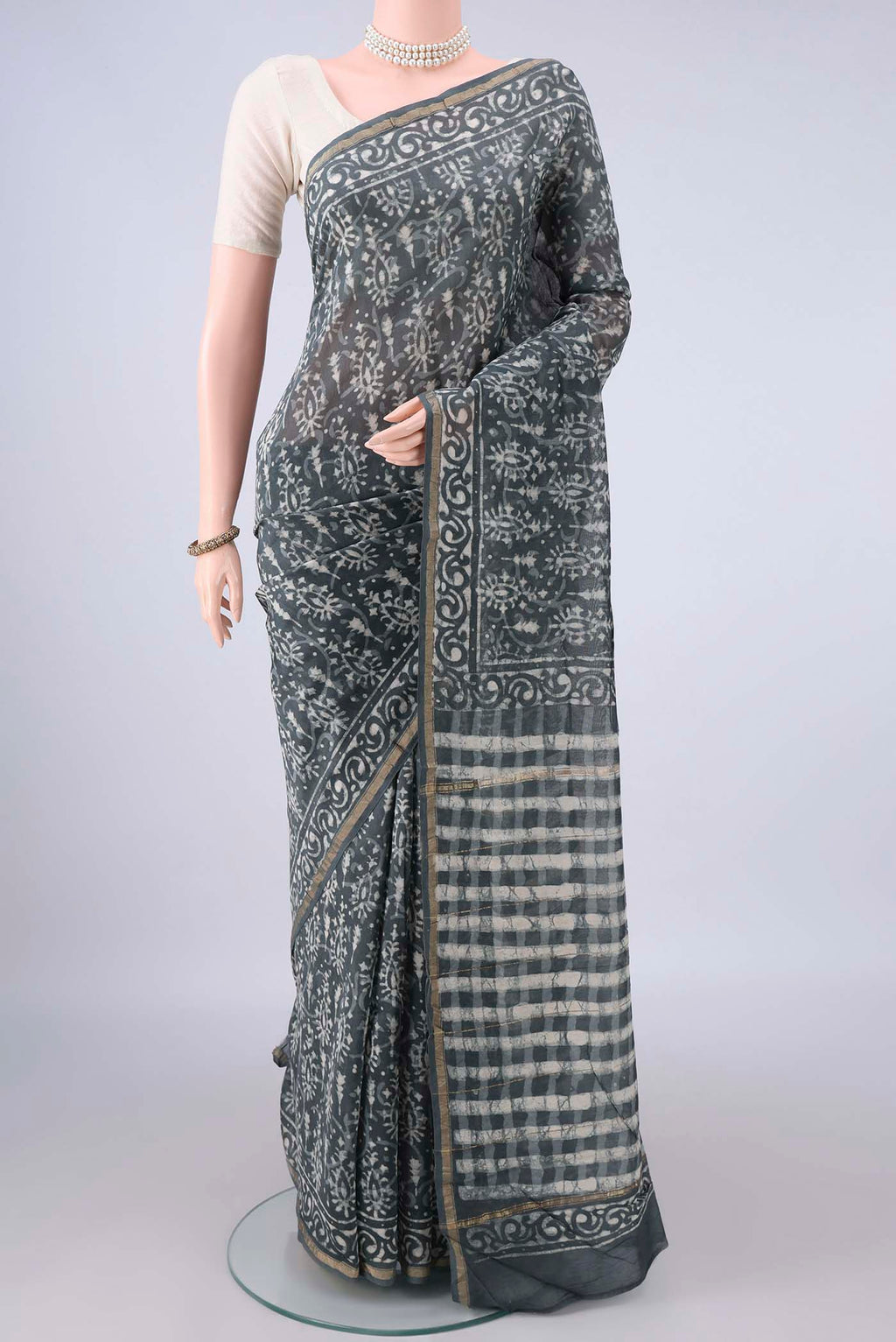 Grey Chanderi Cotton Saree with Batik Print on the body and Thin Zari Line.  displayed on a mannequin
