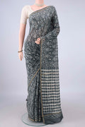 Grey Chanderi Cotton Saree with Batik Print on the body and Thin Zari Line.  displayed on a mannequin
