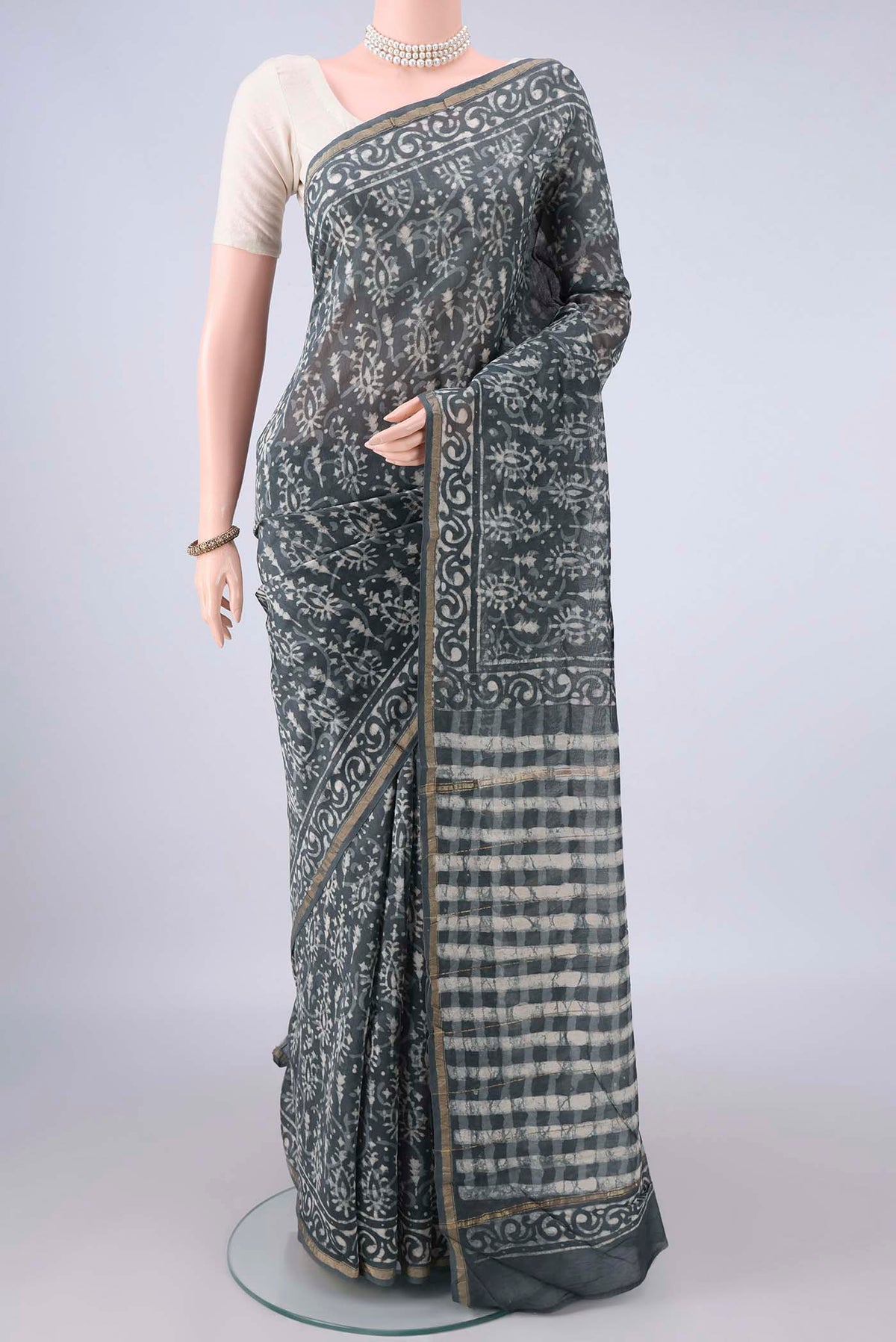 Grey Chanderi Cotton Saree with Batik Print on the body and Thin Zari Line.  displayed on a mannequin