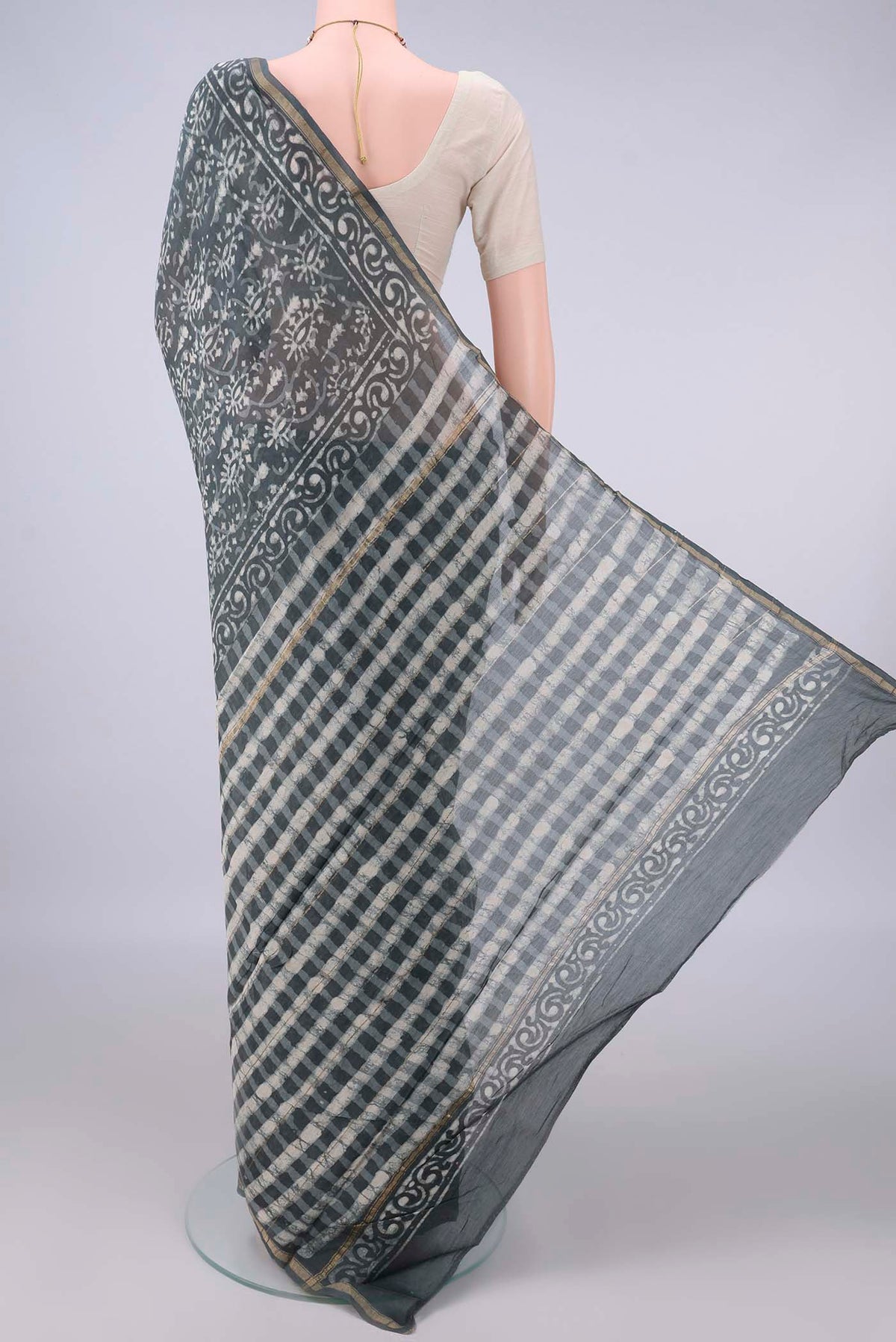 Flat view of Grey Chanderi Cotton Saree with Batik Print on the body and Thin Zari Line. 