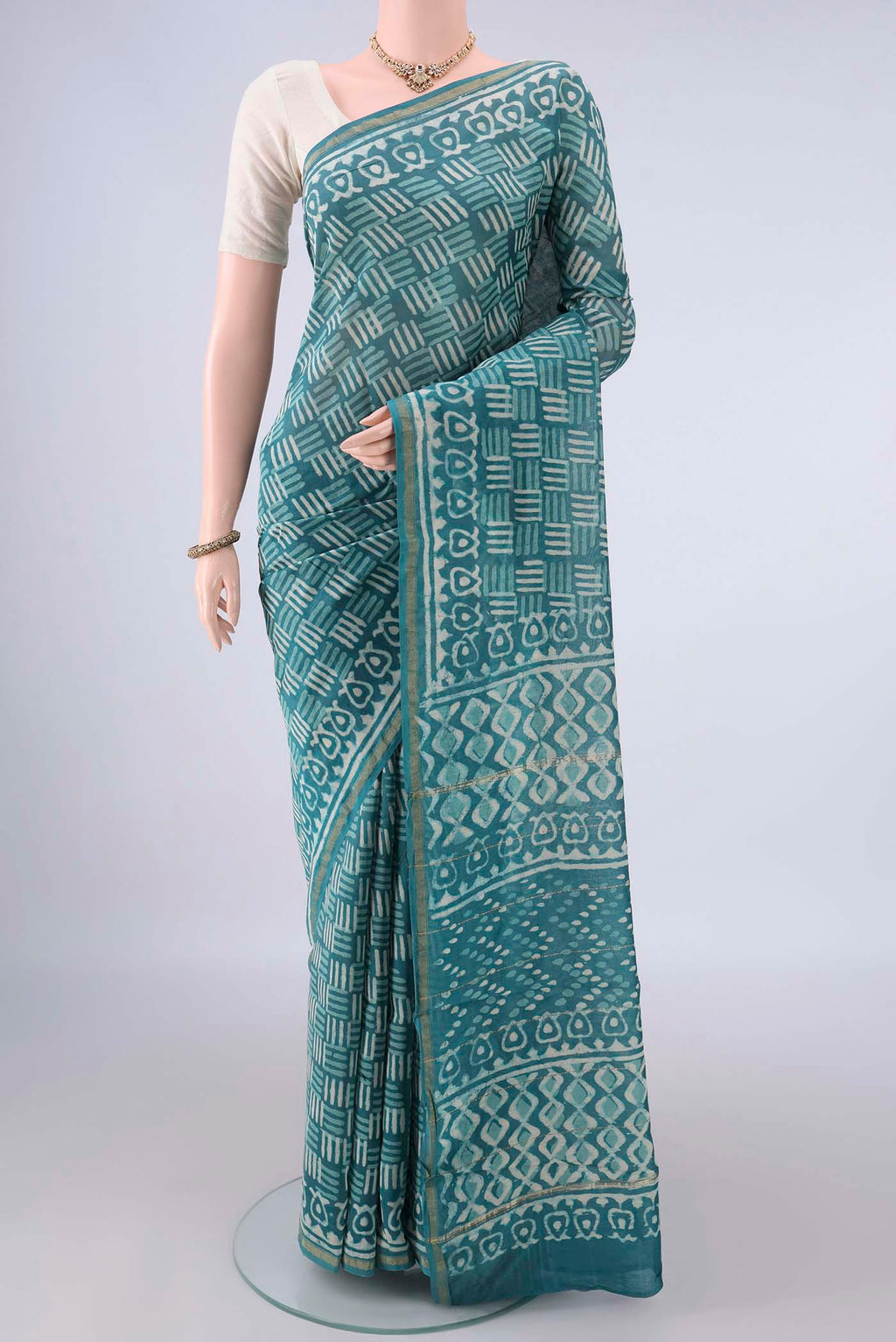 Blue Chanderi Cotton Saree with Batik Print on the body and Thin Zari Line.  displayed on a mannequin