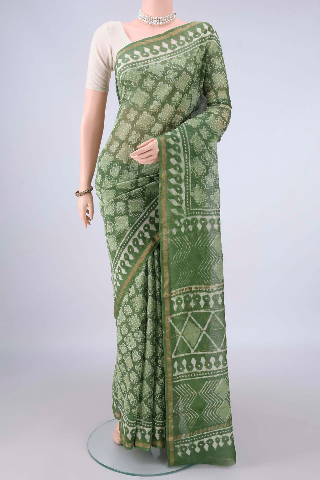 Mehandi Green Chanderi Cotton Saree with Batik Print on the body and Thin Zari Line.  displayed on a mannequin