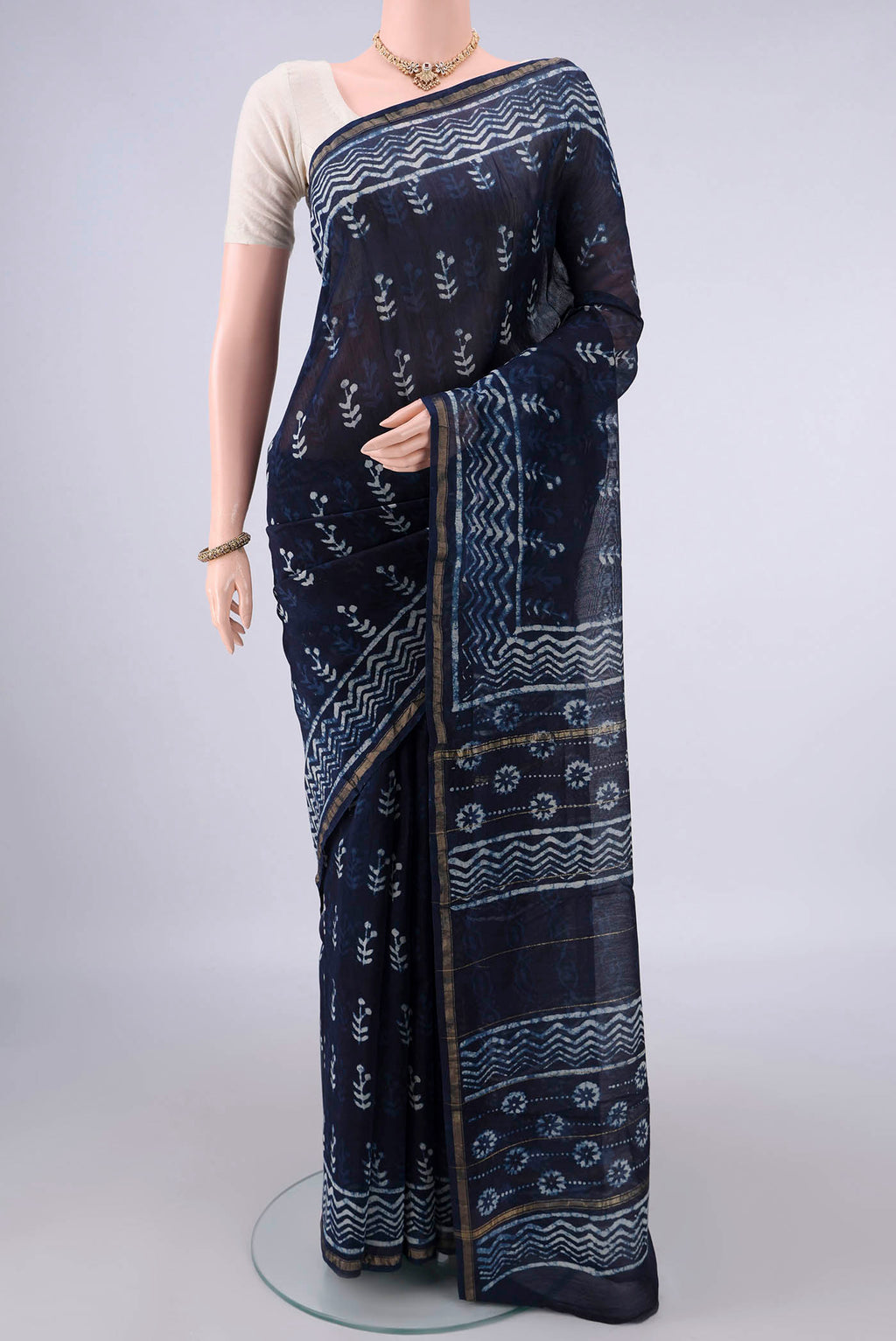 Navy Blue Chanderi Cotton Saree with Batik Print on the body and Thin Zari Line.  displayed on a mannequin