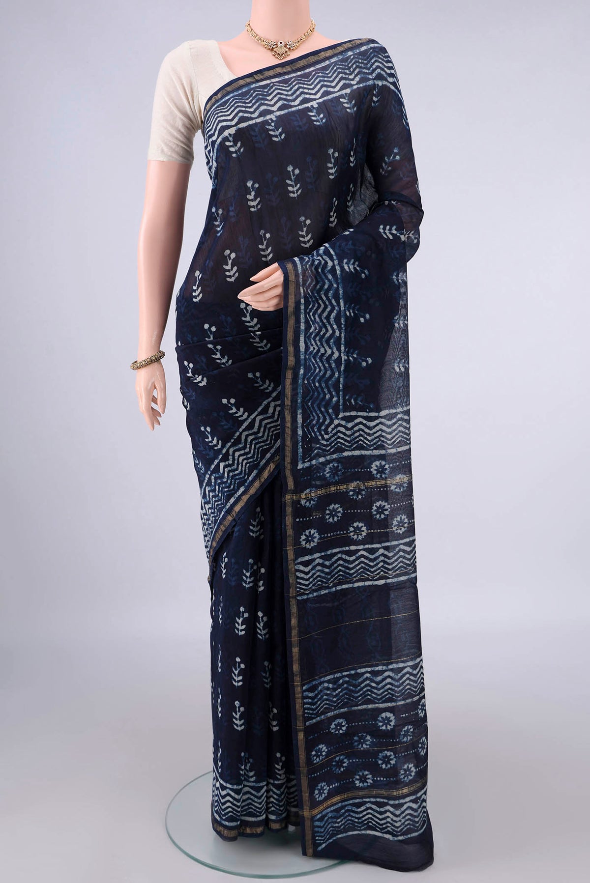 Navy Blue Chanderi Cotton Saree with Batik Print on the body and Thin Zari Line.  displayed on a mannequin