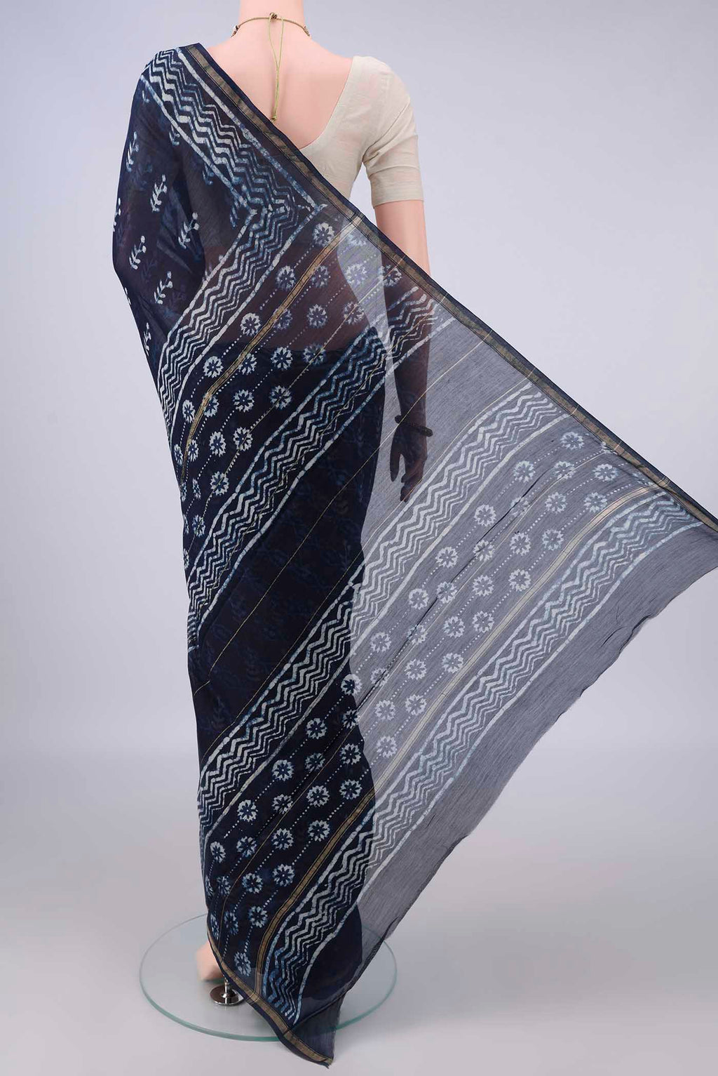 Flat view of Navy Blue Chanderi Cotton Saree with Batik Print on the body and Thin Zari Line. 