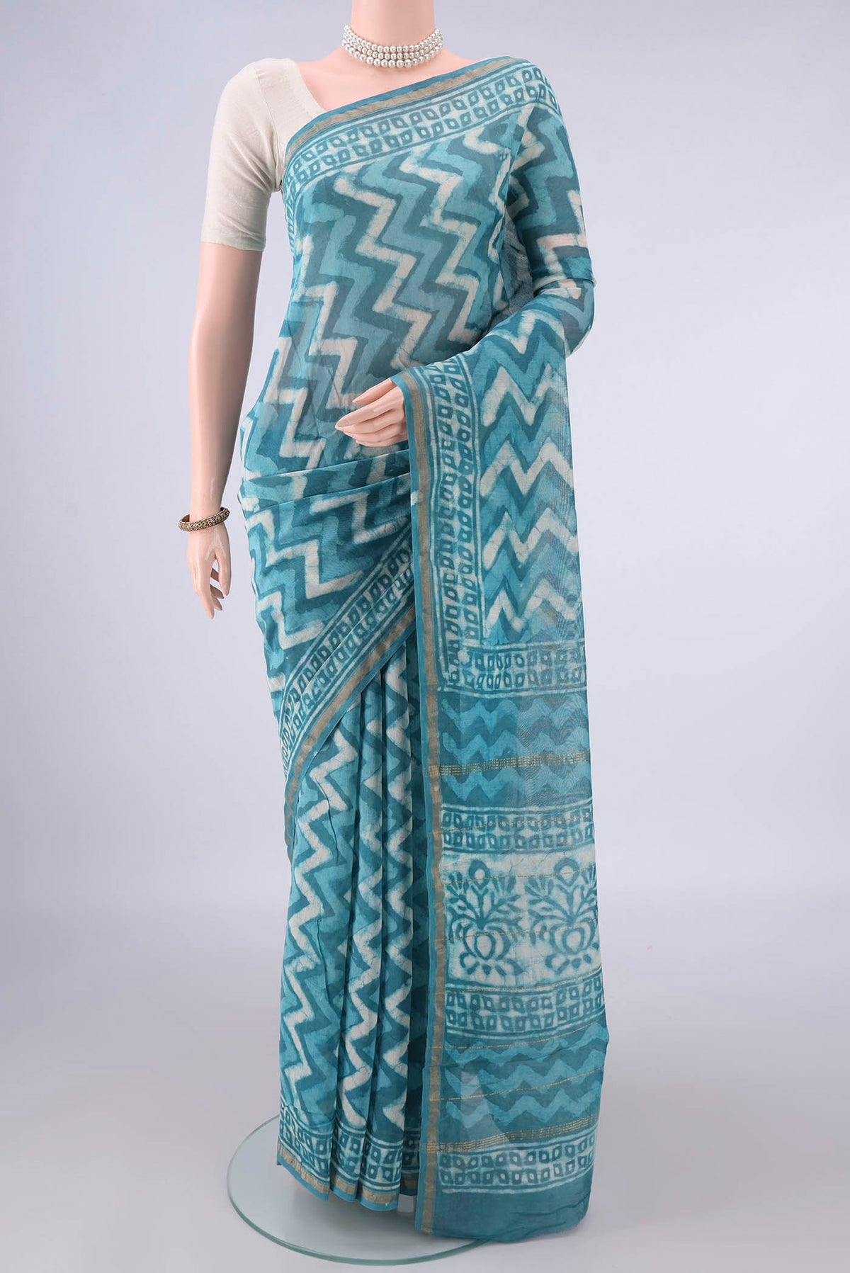 Blue Chanderi Cotton Saree with Batik Print on the body and Thin Zari Line.  displayed on a mannequin