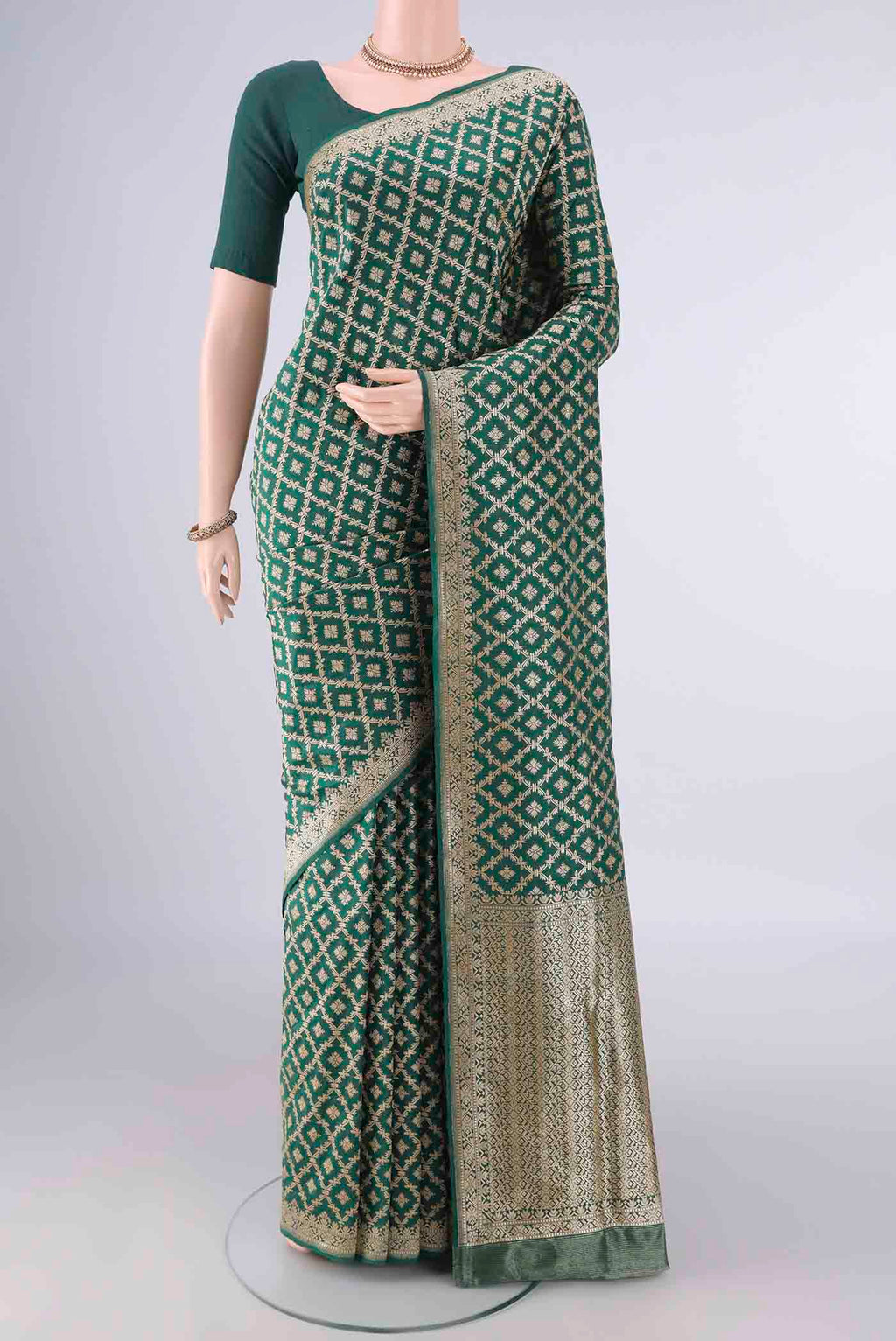 Pure Silk Green Banarasi Saree with Zari Brocade on the body and Zari Border.  displayed on a mannequin