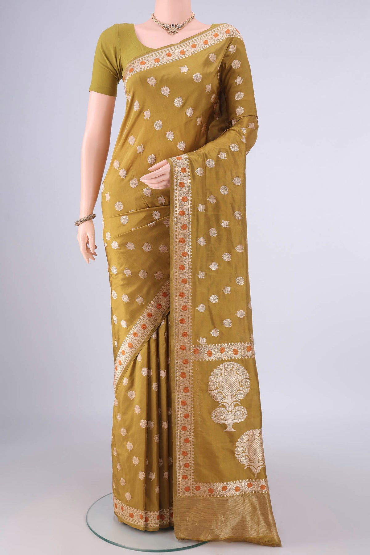 Pure Silk Mustard Banarasi Saree with Zari Butta on the body and Zari And Thread Border.  displayed on a mannequin
