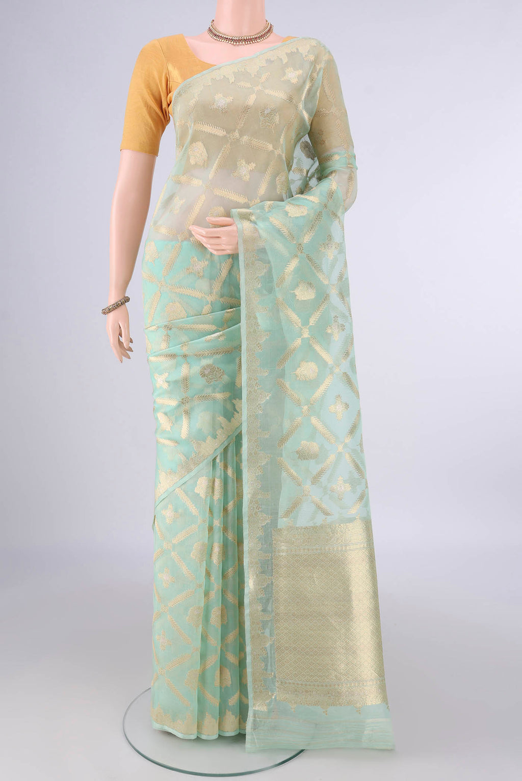 Pure Silk Mint Green Banarasi Kora Saree with Zari Brocade on the body and Zari Border.  displayed on a mannequin