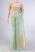 Pure Silk Mint Green Banarasi Kora Saree with Zari Brocade on the body and Zari Border.  displayed on a mannequin