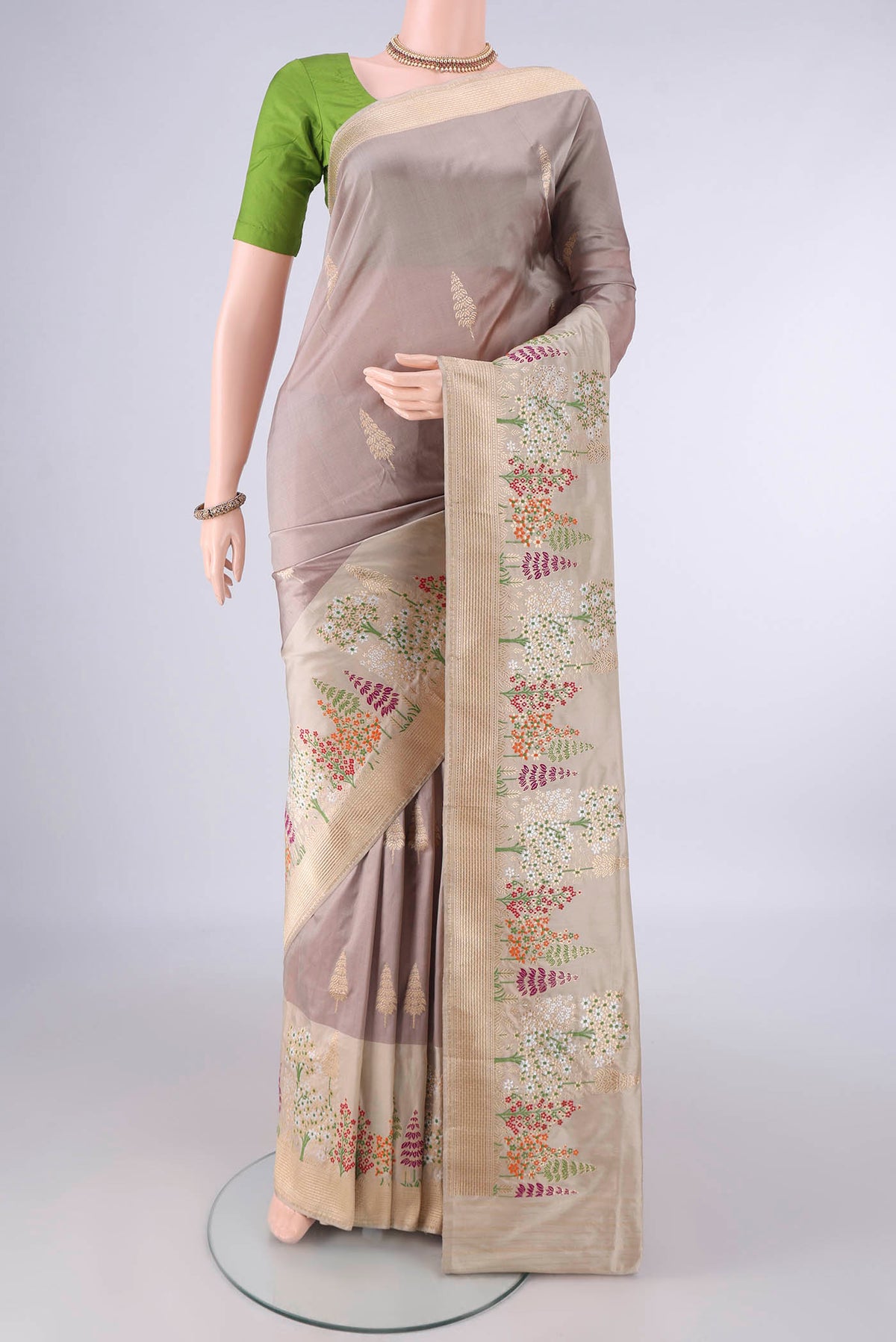 Pure Silk Dark Beige Banarasi Saree with Zari Butta on the body and Meenakari Border.  displayed on a mannequin
