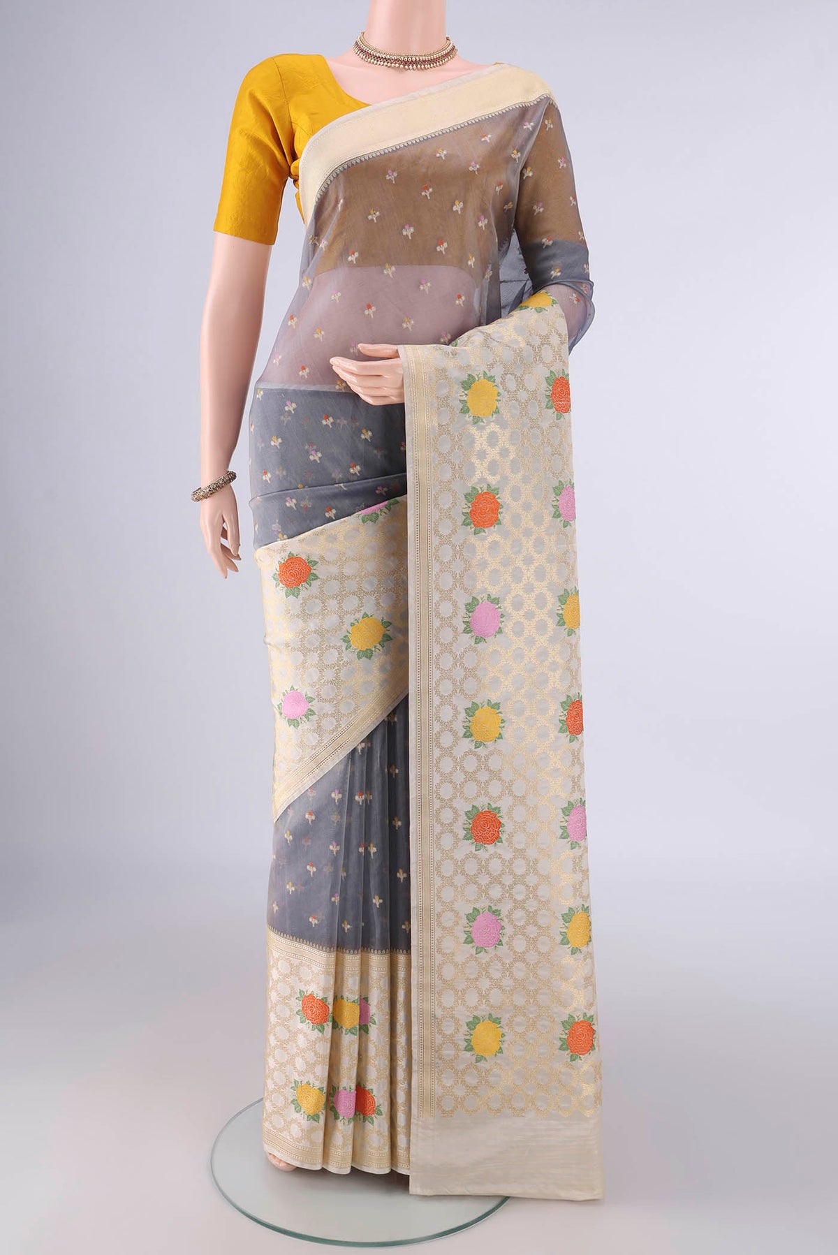 Pure Silk Blue Grey Banarasi Kora Saree with Zari And Thread Butta on the body and Zari And Thread Border.  displayed on a mannequin