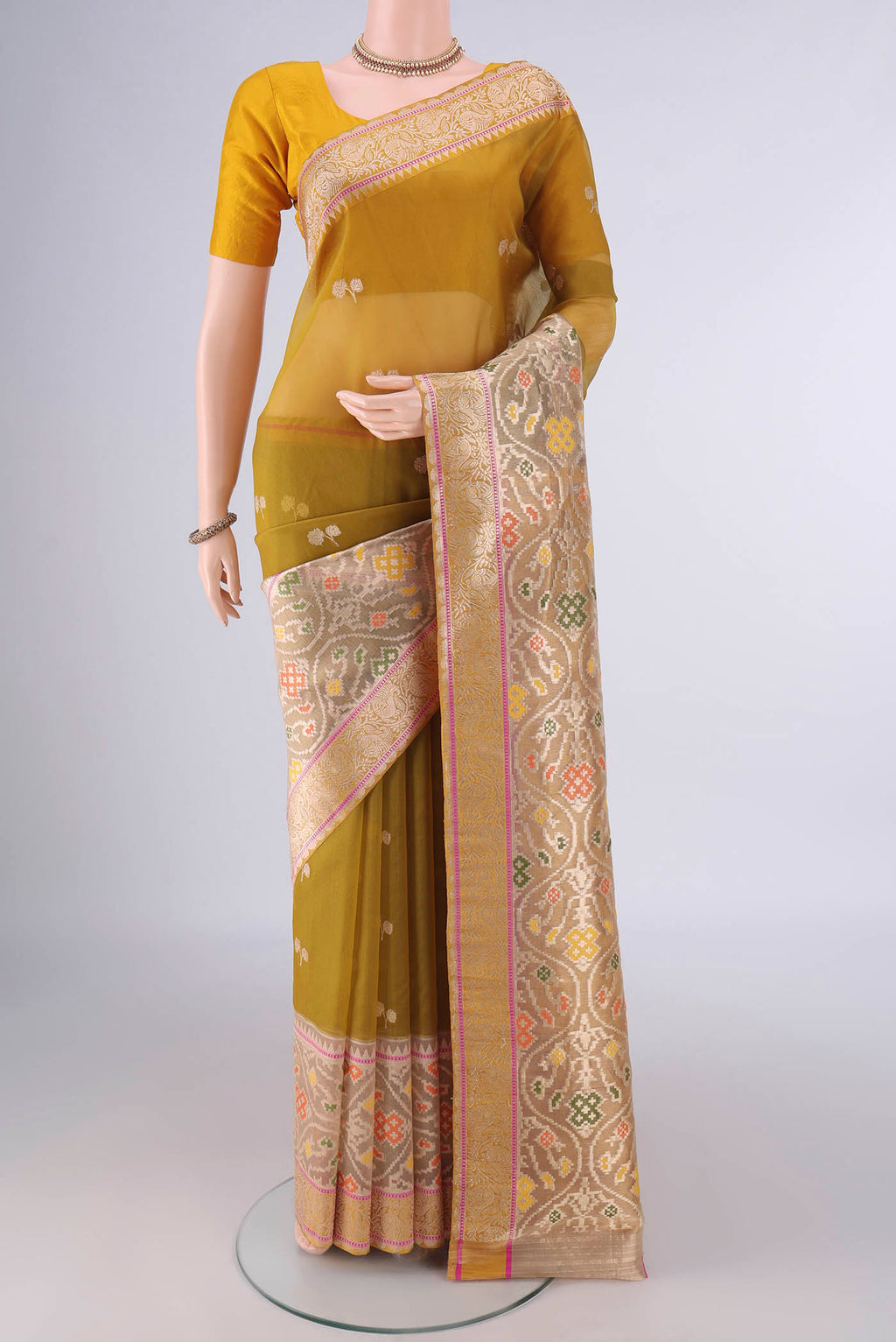 Pure Silk Mustard Banarasi Kora Saree with Zari Butta on the body and Zari Border.  displayed on a mannequin