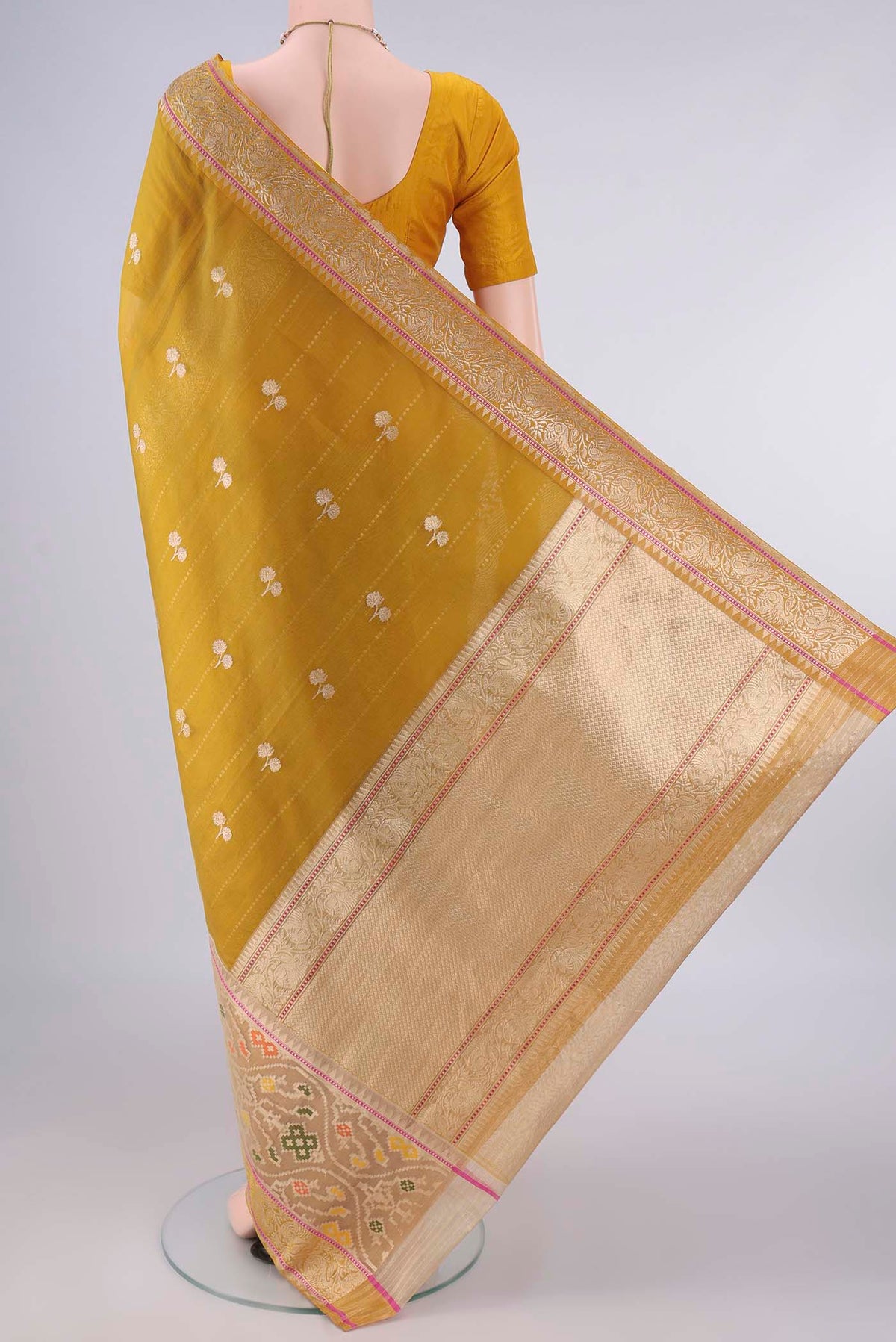 Flat view of Pure Silk Mustard Banarasi Kora Saree with Zari Butta on the body and Zari Border. 