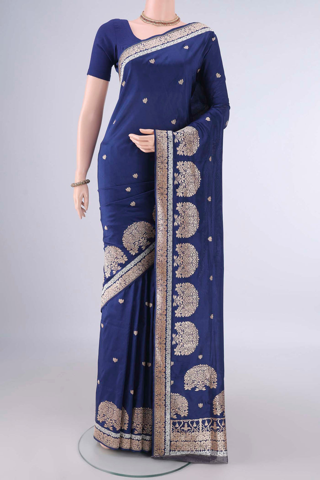 Pure Silk Dark Blue Banarasi Saree with Zari Butta on the body and Zari Border.  displayed on a mannequin