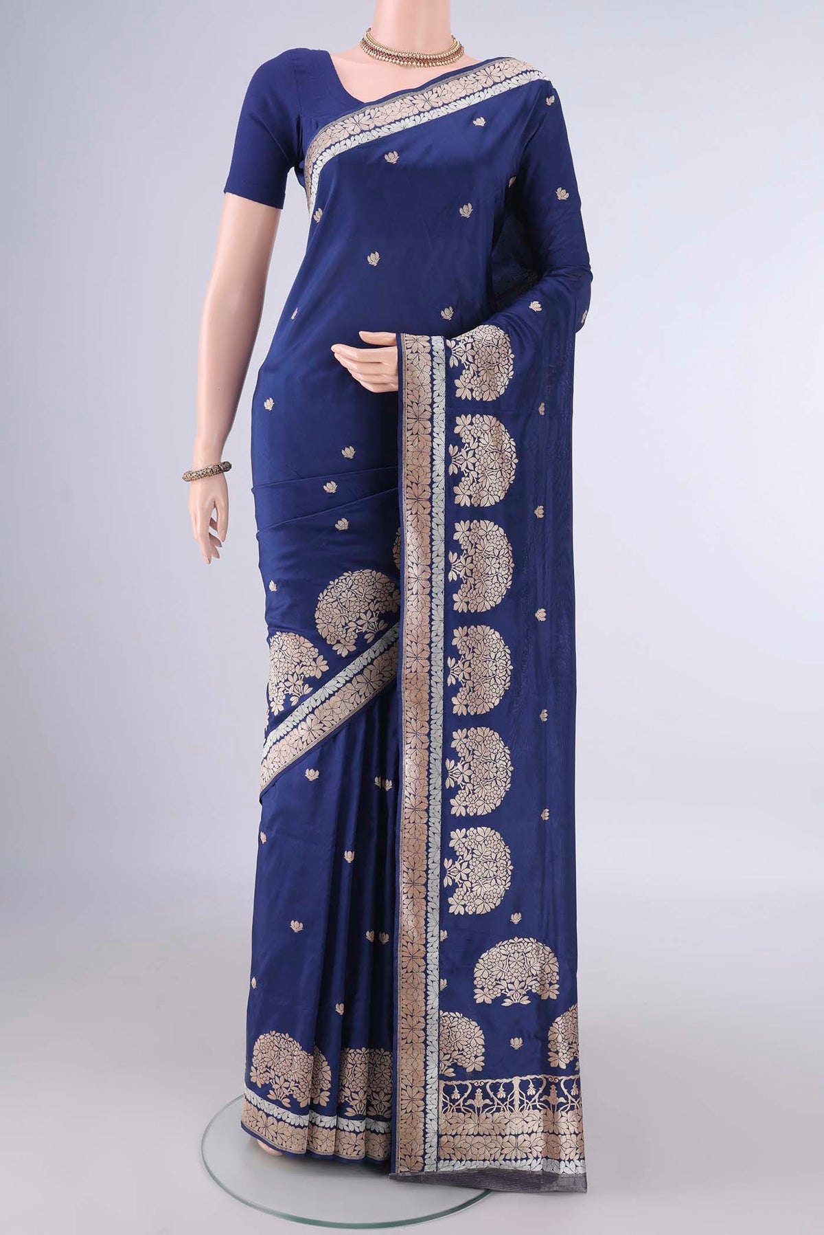 Pure Silk Dark Blue Banarasi Saree with Zari Butta on the body and Zari Border.  displayed on a mannequin