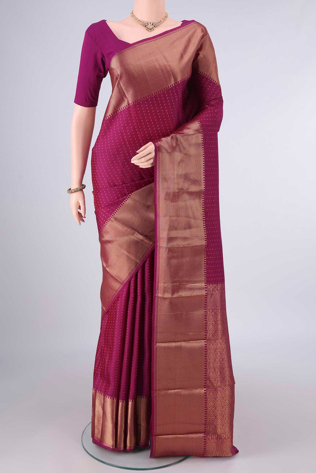 Pure Silk Magenta Kanjivaram Saree with Zari Butta on the body and Zari Border.  displayed on a mannequin