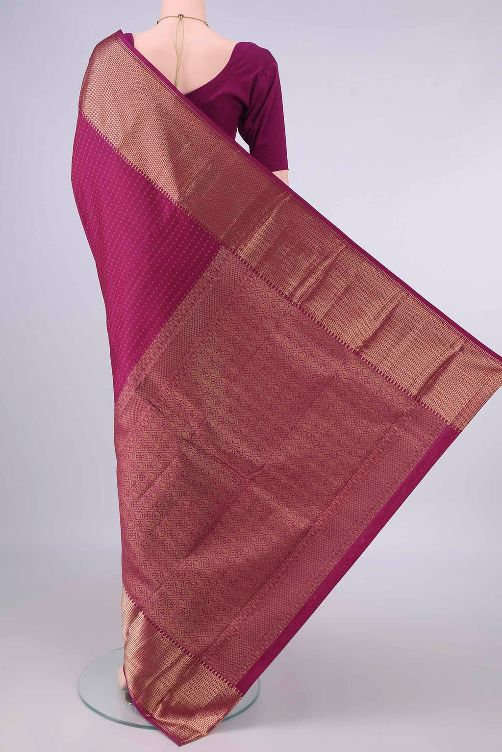 Flat view of Pure Silk Magenta Kanjivaram Saree with Zari Butta on the body and Zari Border. 