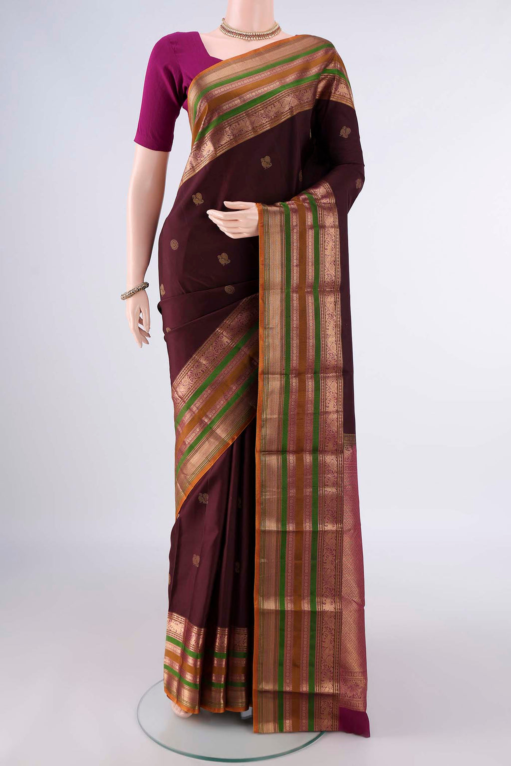 Pure Silk Coffee Brown Kanjivaram Saree with Zari Butta on the body and Zari Border.  displayed on a mannequin