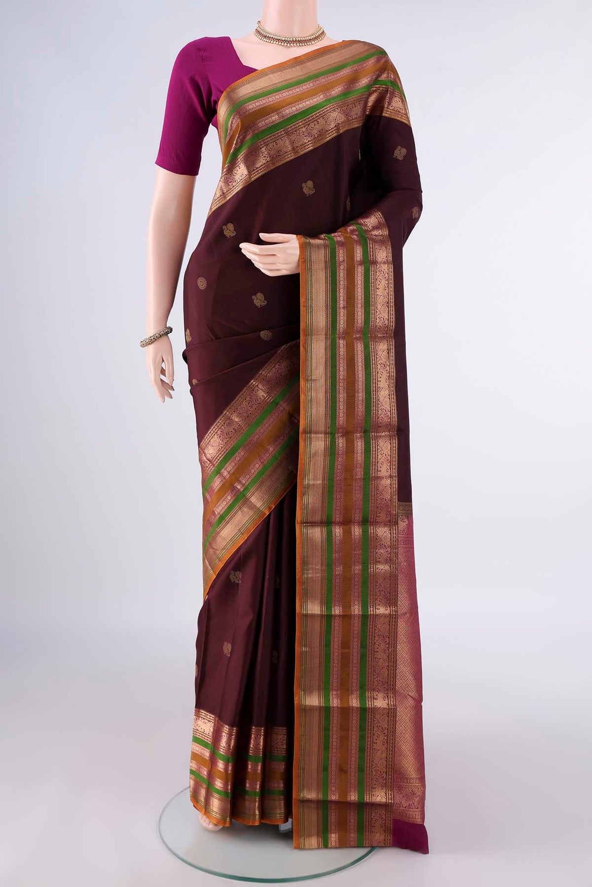 Pure Silk Coffee Brown Kanjivaram Saree with Zari Butta on the body and Zari Border.  displayed on a mannequin