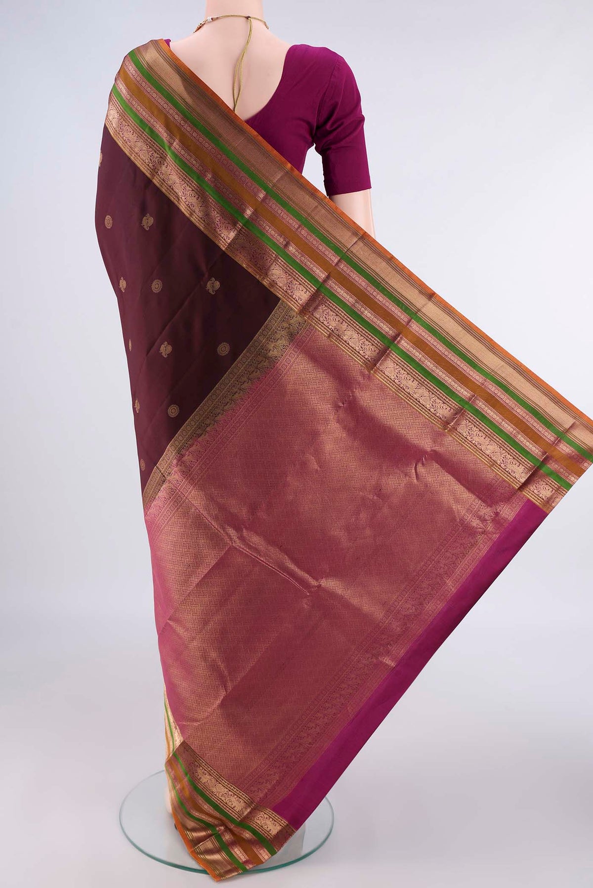 Flat view of Pure Silk Coffee Brown Kanjivaram Saree with Zari Butta on the body and Zari Border. 