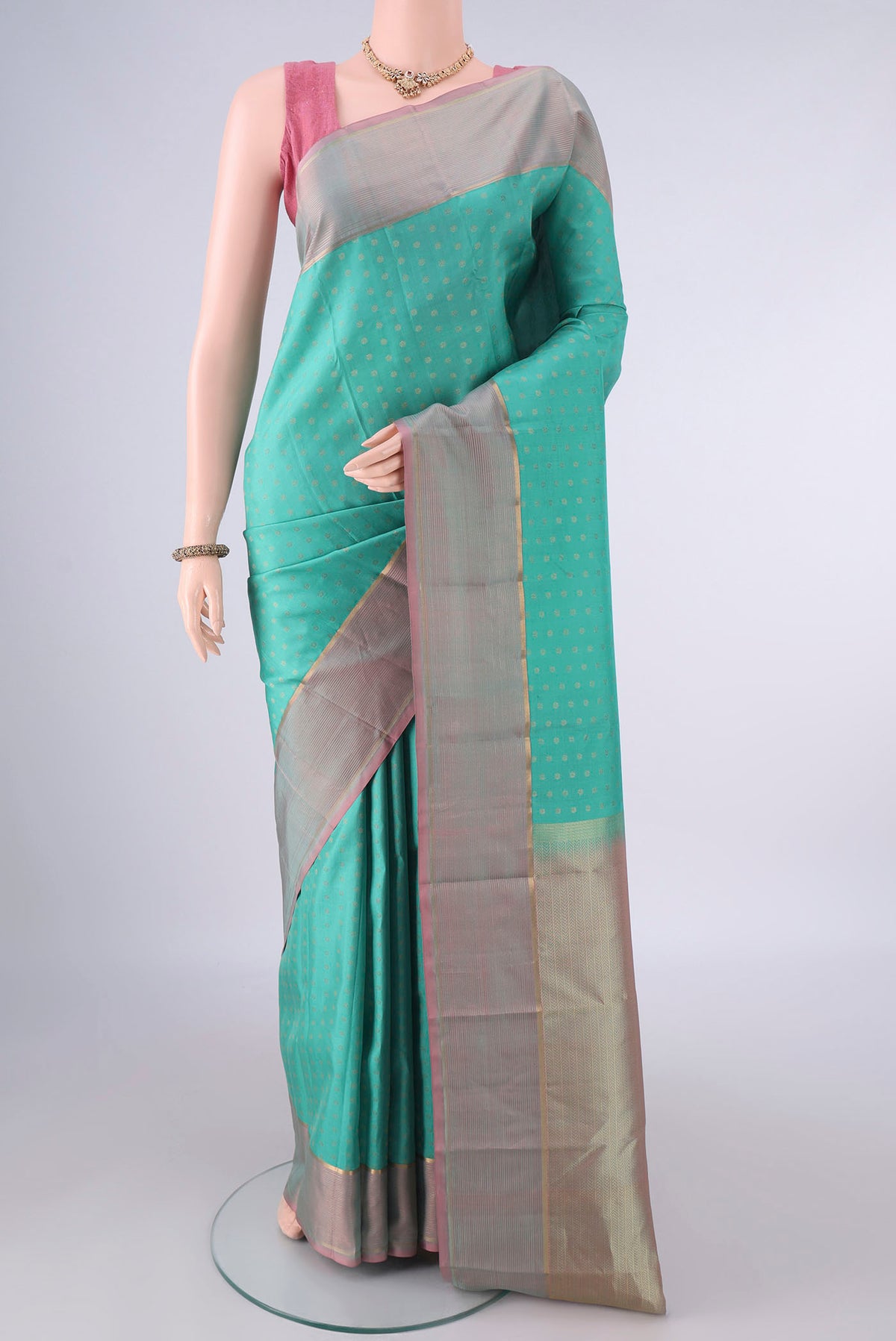 Pure Silk Turquoise Kanchipuram Saree with Zari Butta on the body and Zari Border.  displayed on a mannequin