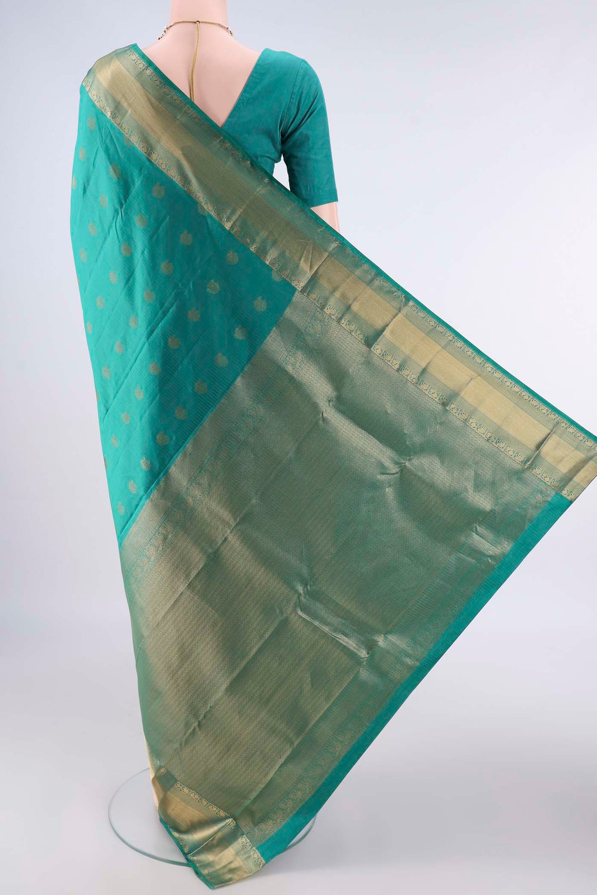 Flat view of Pure Silk Sea Green Kanchipuram Saree with Zari Butta on the body and Zari Border. 