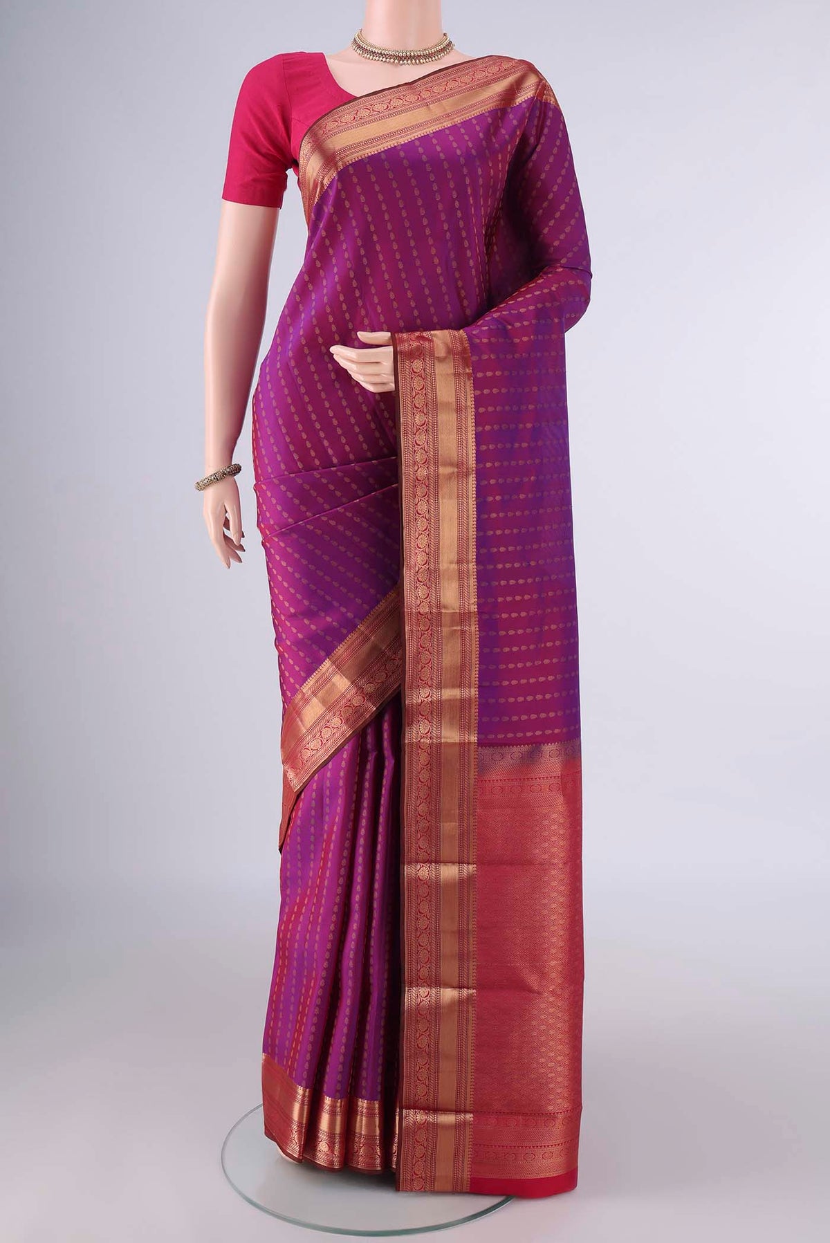 Pure Silk Purple Kanchipuram Saree with Zari Butta on the body and Zari Border.  displayed on a mannequin