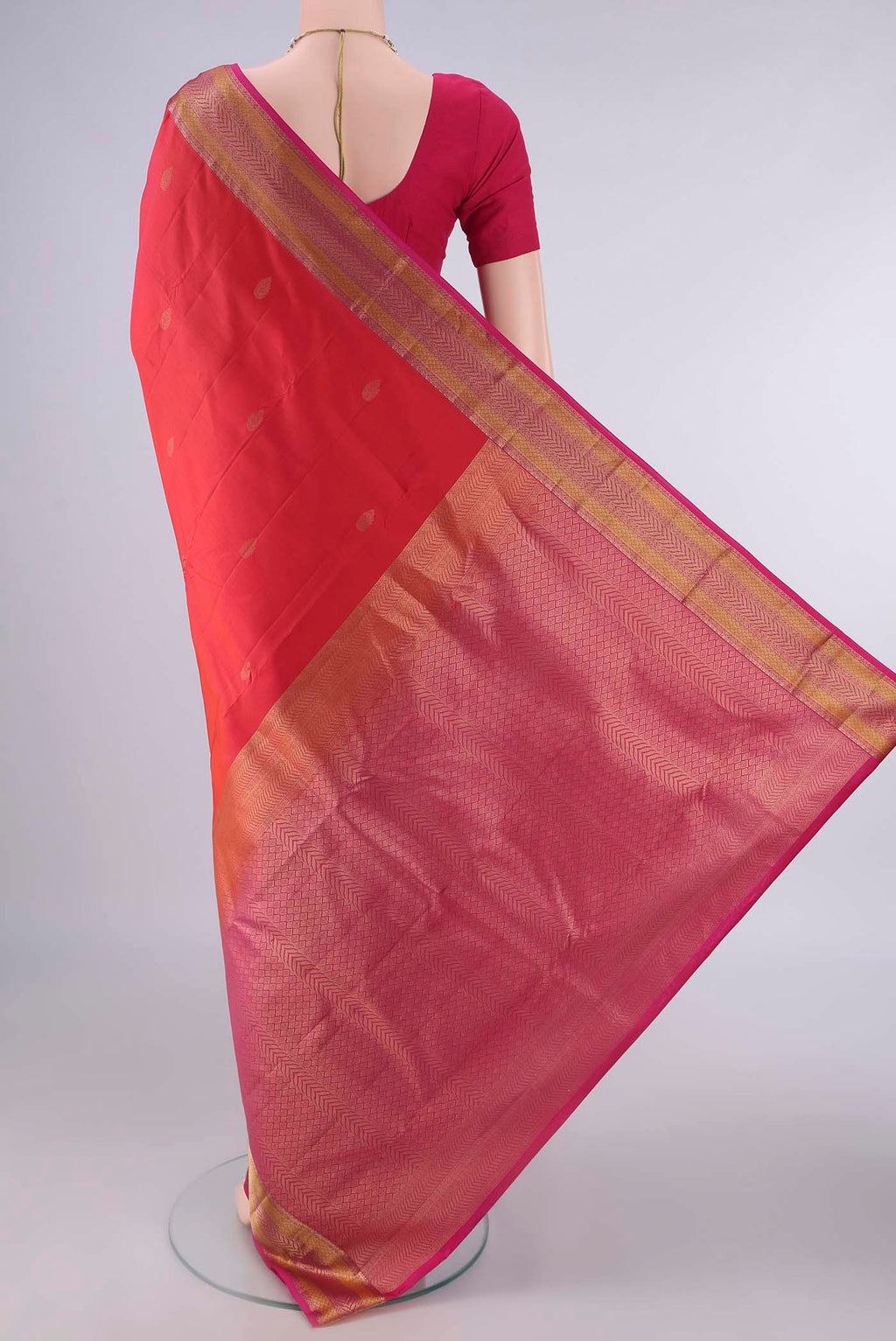 Flat view of Pure Silk Orange Kanchipuram Saree with Zari Butta on the body and Zari Border. 