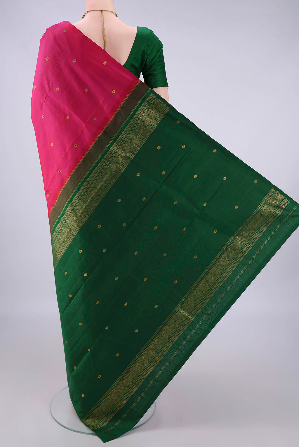 Flat view of Pure Silk Rani Pink Kanchipuram Saree with Zari And Thread Butta on the body and Without Border. 