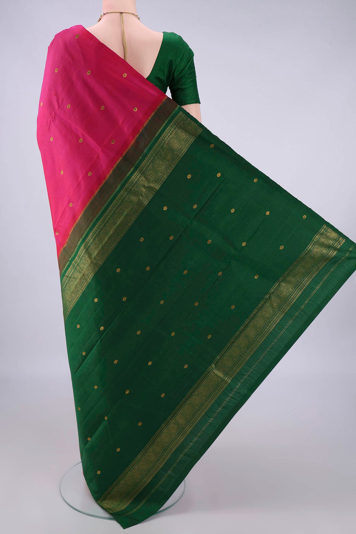 Flat view of Pure Silk Rani Pink Kanchipuram Saree with Zari And Thread Butta on the body and Without Border. 
