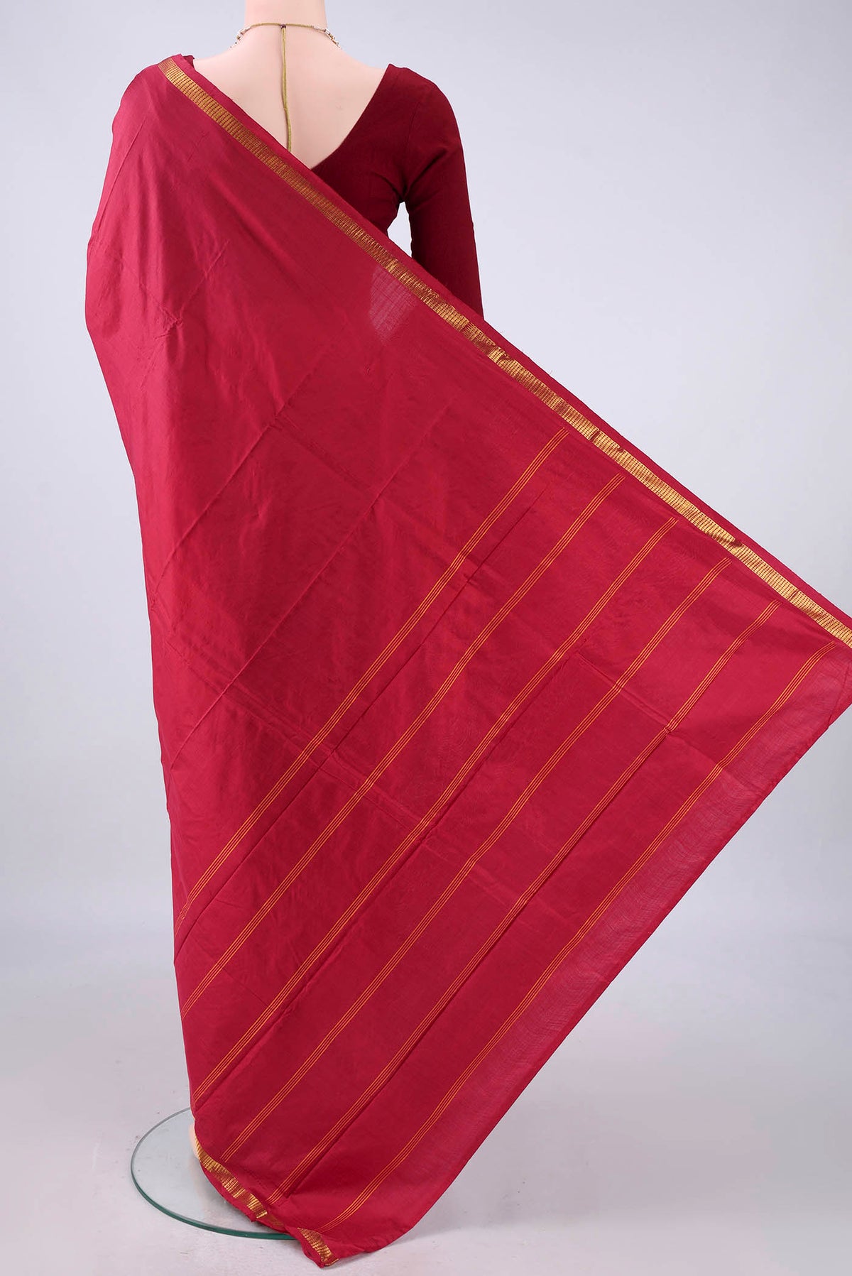 Flat view of Pure Silk Maroon Kanchipuram Saree with Plain Body and Zari Border. 