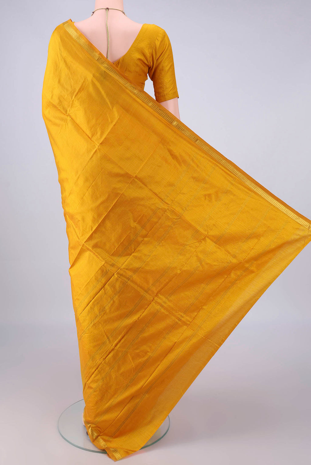 Flat view of Pure Silk Yellow Kanchipuram Saree with Plain Body and Zari Border. 