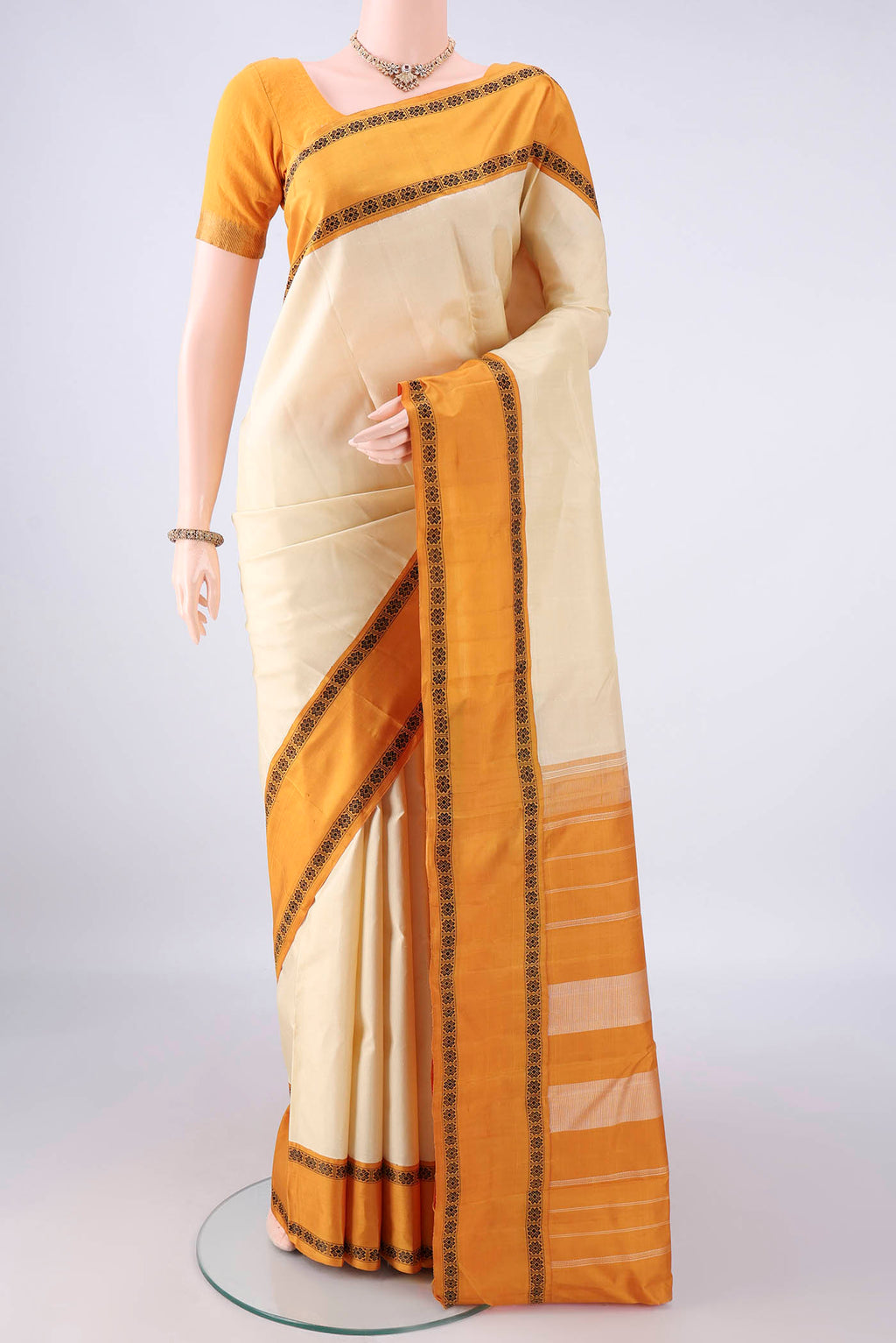 Pure Silk Off White Kanjivaram Saree with Plain Body and Thread Border.  displayed on a mannequin