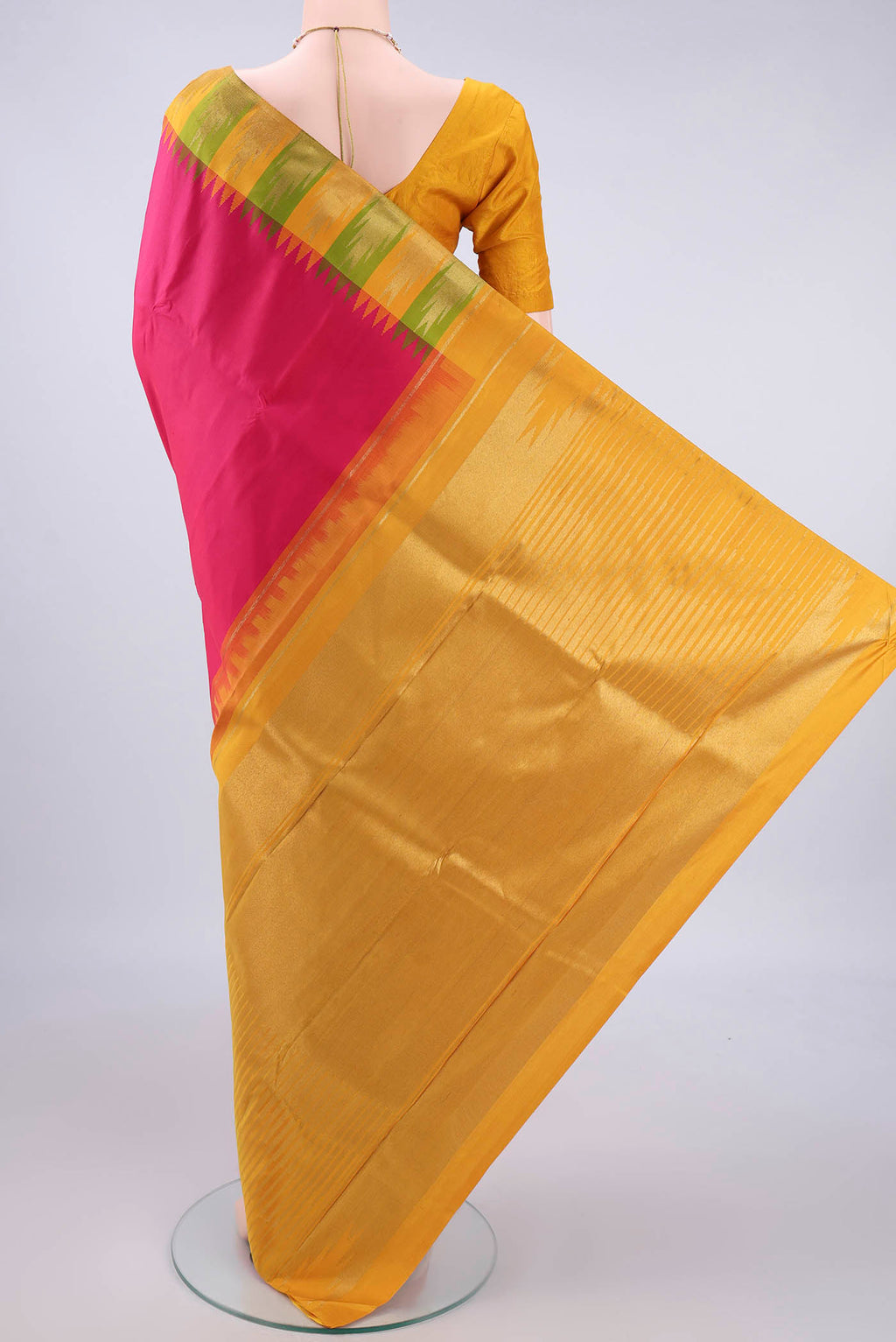 Flat view of Pure Silk Rani Pink Kanjivaram Saree with Plain Body and Temple Border. 