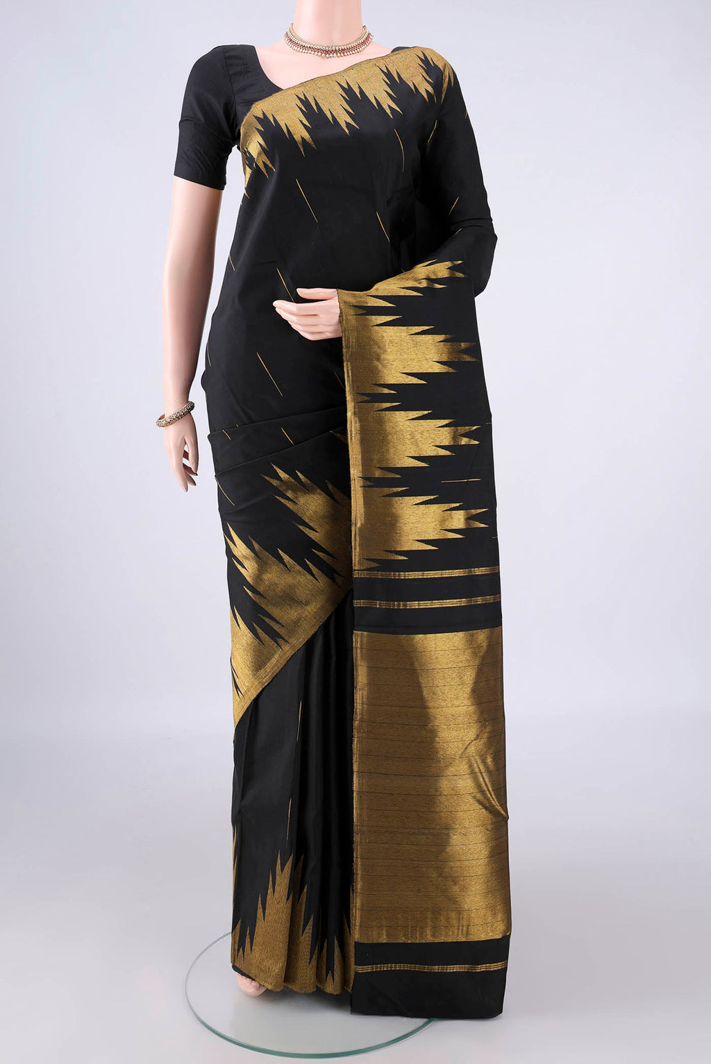 Pure Silk Black Kanjivaram Saree with Zari Butta on the body and Temple Border.  displayed on a mannequin
