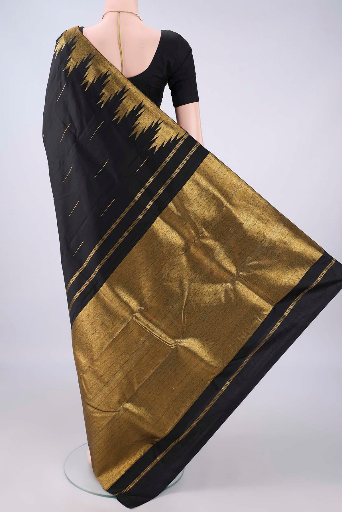 Flat view of Pure Silk Black Kanjivaram Saree with Zari Butta on the body and Temple Border. 