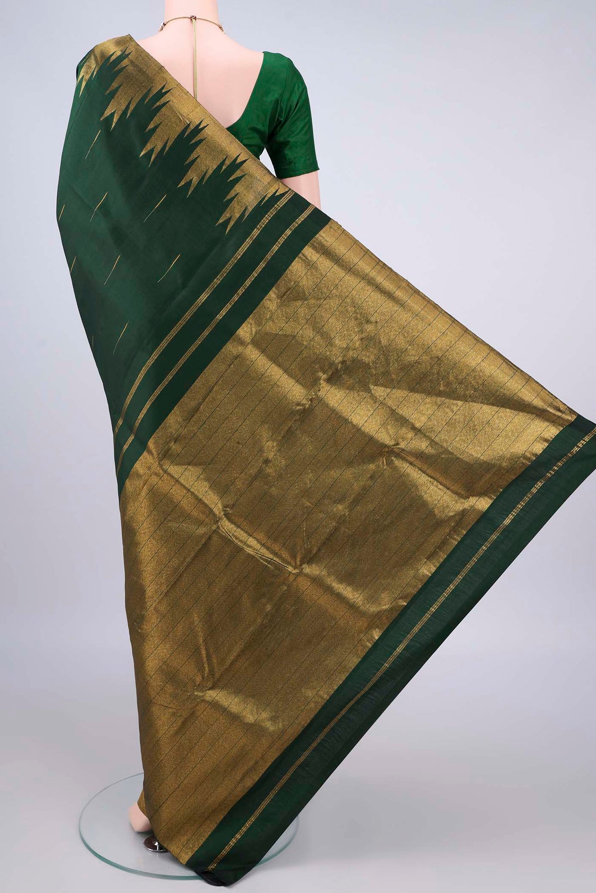 Flat view of Pure Silk Bottle Green Kanjivaram Saree with Zari Butta on the body and Temple Border. 
